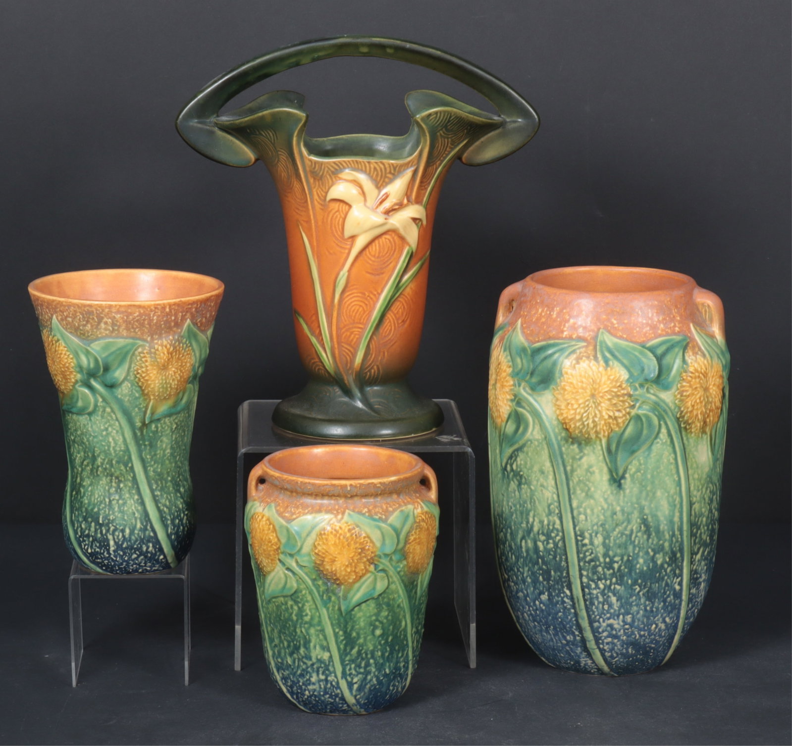 Group of Roseville Ceramic Vases: A grouping of Roseville ceramics including three with sunflower motif, together with a Roseville Freesia pattern basket.
