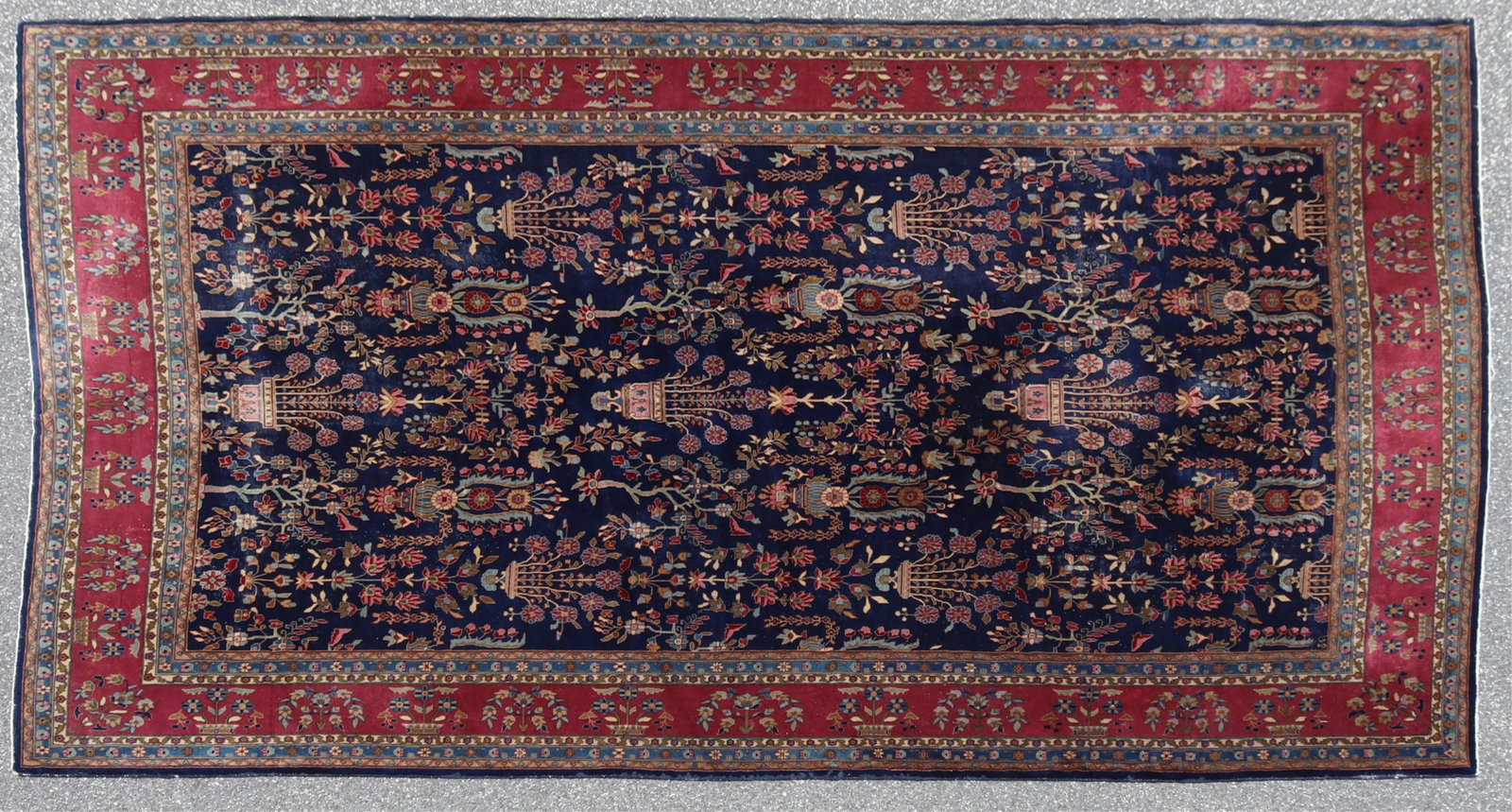 Kandahar Indo Sarouk Rug 10-1 x 14-1: Kandahar Indo Sarouk Rug, c.1935, hand knotted Manchester wool, field with dark blue ground rows of floral stylized garden bouquet and vine scroll motifs, colors include tan, taupe blue and rust, bord