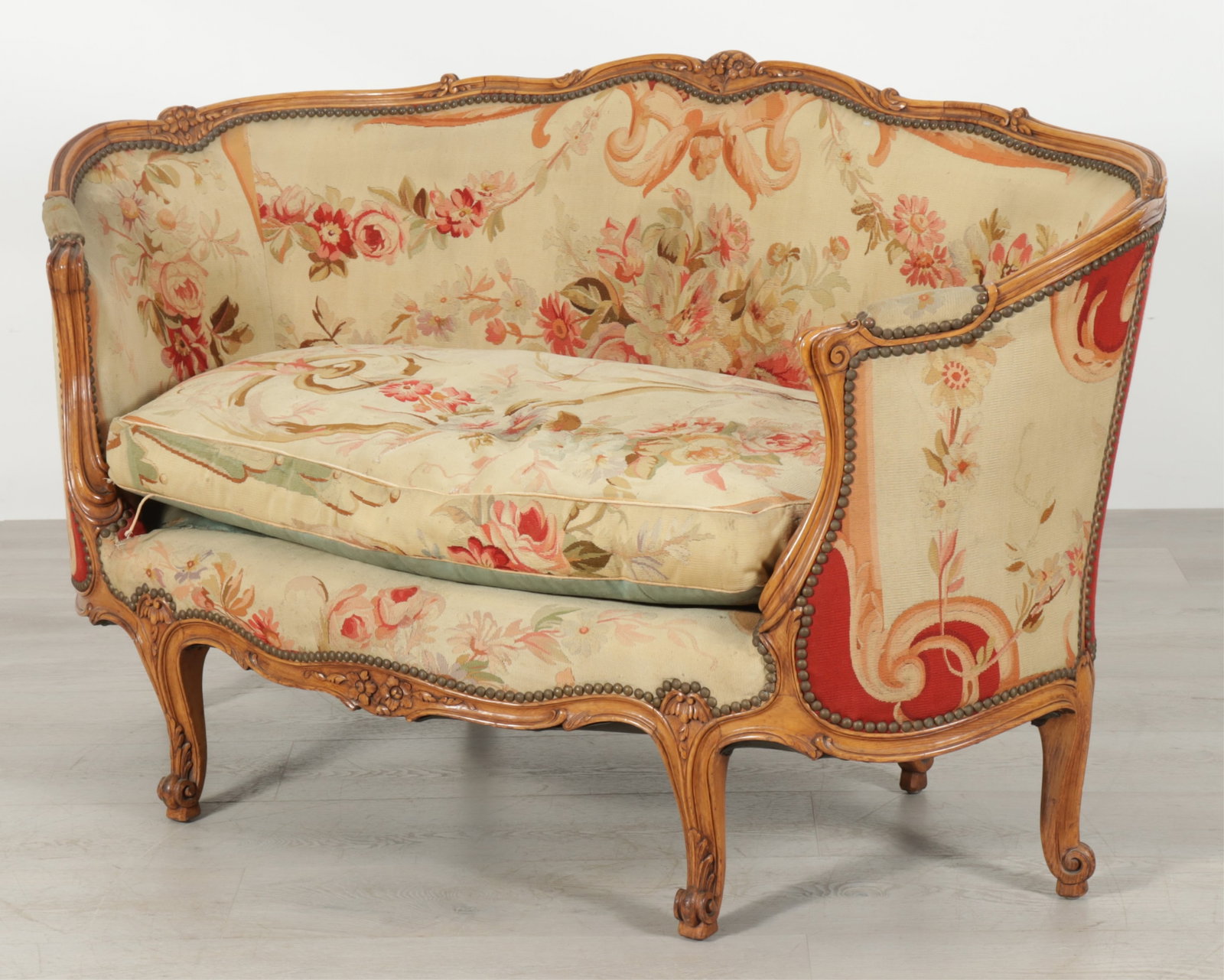 French Provincial Aubusson Upholstered Canape: French provincial carved wooden canape upholstered in Aubusson woven textile, down filled cushion, nailhead trim