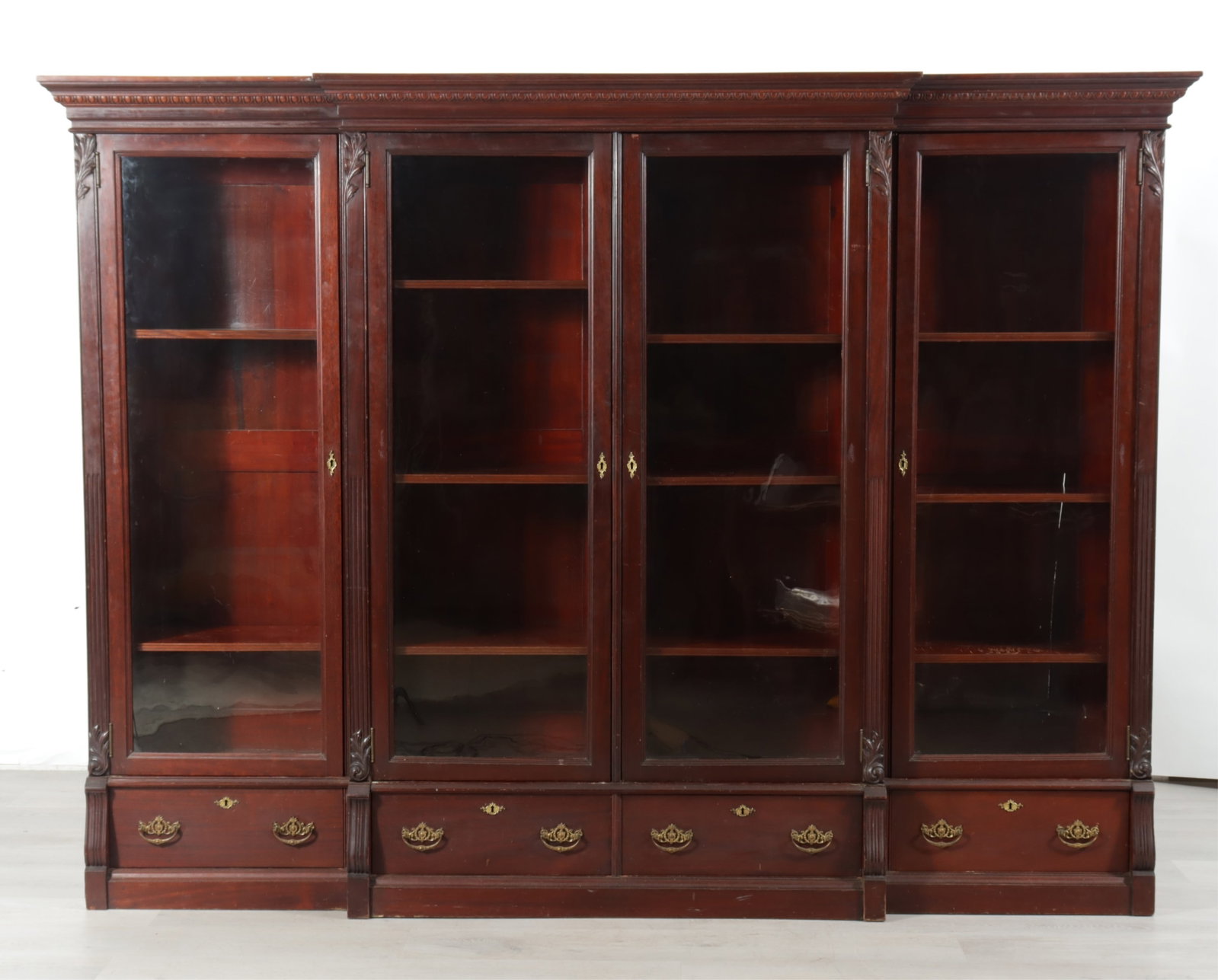 Regency Style Breakfront: Regency style breakfront, 20th century. Four glass panel doors enclosing adjustable shelves, over four drawers.
