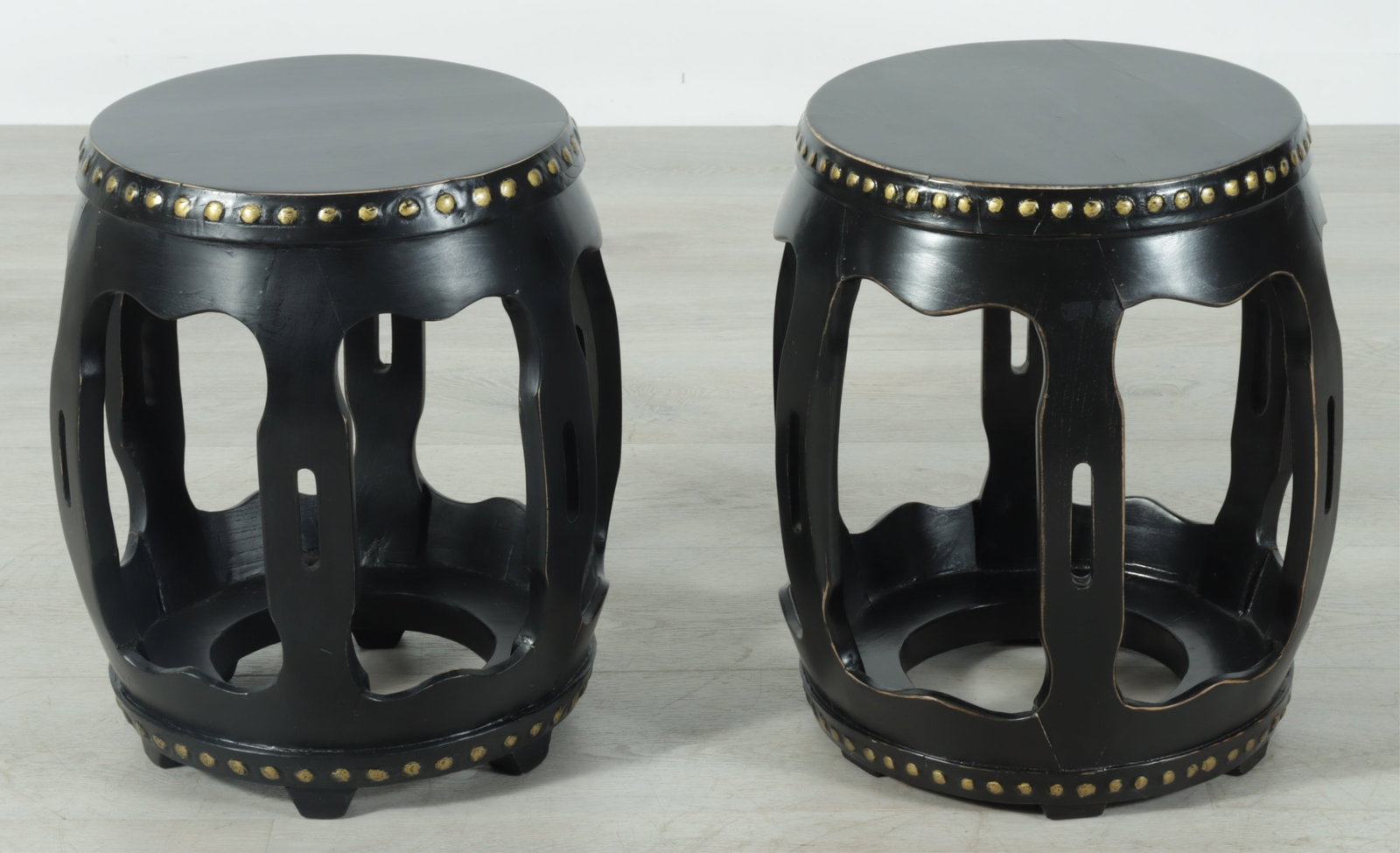 Pair of Ming Style Drum Tables: Pair of Chinese Ming style drum tables, black painted wood with nailhead trim, gold paint detail