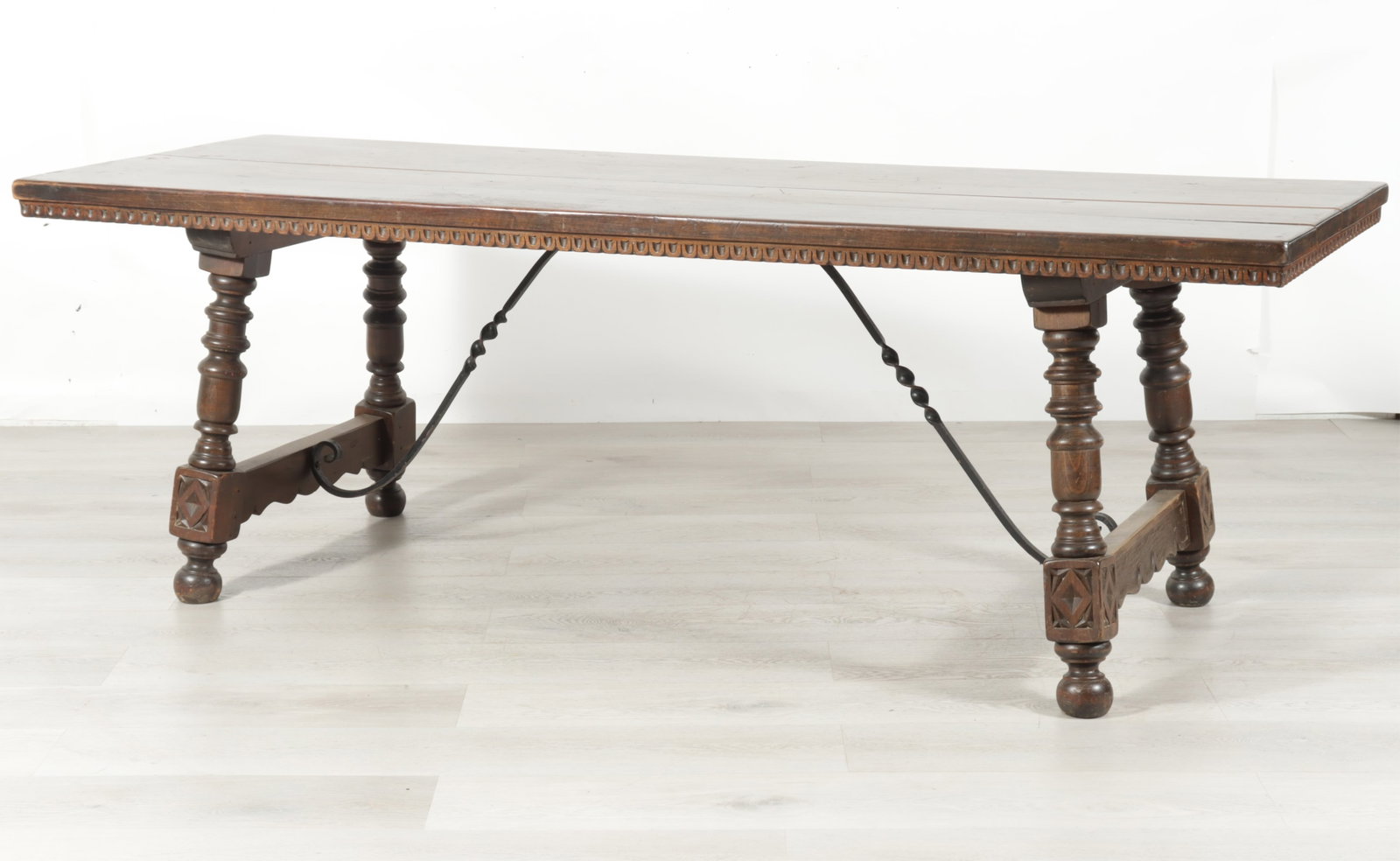 Spanish Colonial Revival Style Dining Table: Spanish colonial revival style dining table, canted leg with ball foot, scrolled ironwork base, possibly oak