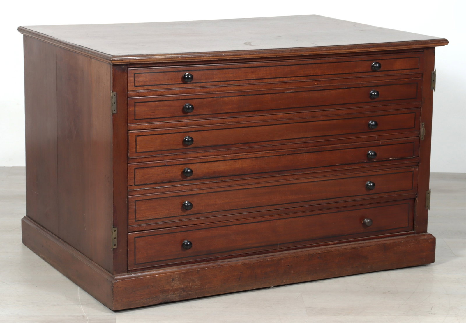 English Mahogany Nautical Map Flat File: English inlaid mahogany nautical map flat file, six graduated inlaid drawers, black knob pulls, on casters. Partial label on rear. See photos for details.