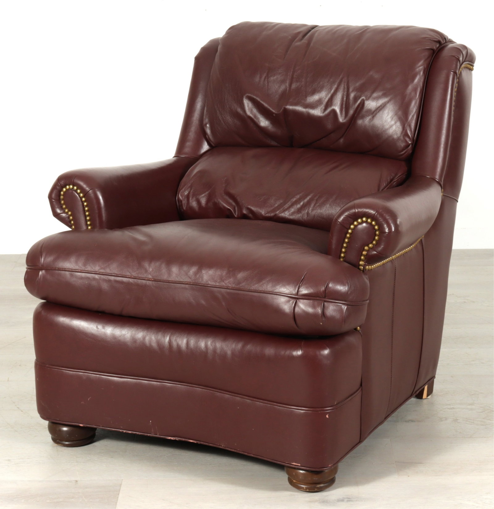 Hancock and Moore Leather Lounge Chair: Hancock and Moore lounge chair upholstered in a burgundy leather, bun feet, nail head trim