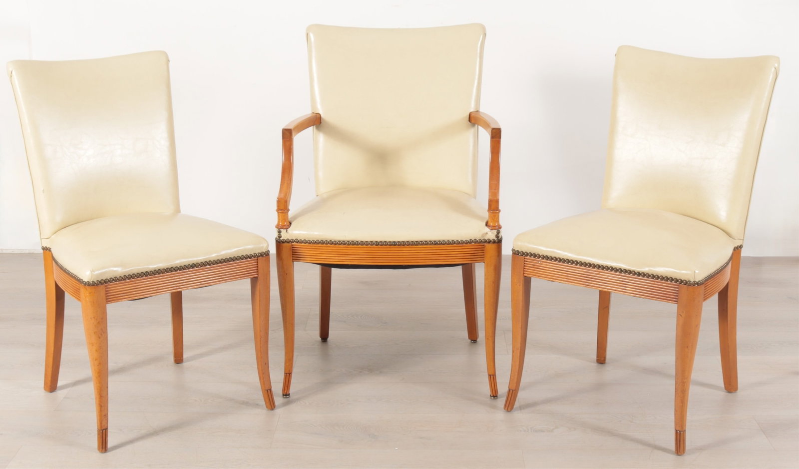 Regency Style Cherry Sitting Suite: Three Regency style cherry chairs including one arm chair and a pair of side chairs upholstered in cream leatherette.