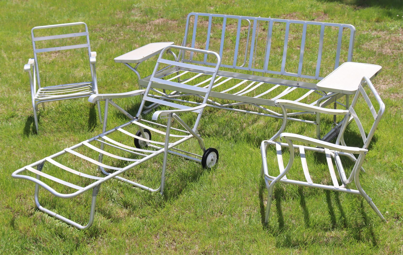 Retro Aluminum Patio Seat Furniture Suite: Retro aluminum patio furniture suite, including a glider, two armchairs, and a chaise lounge.