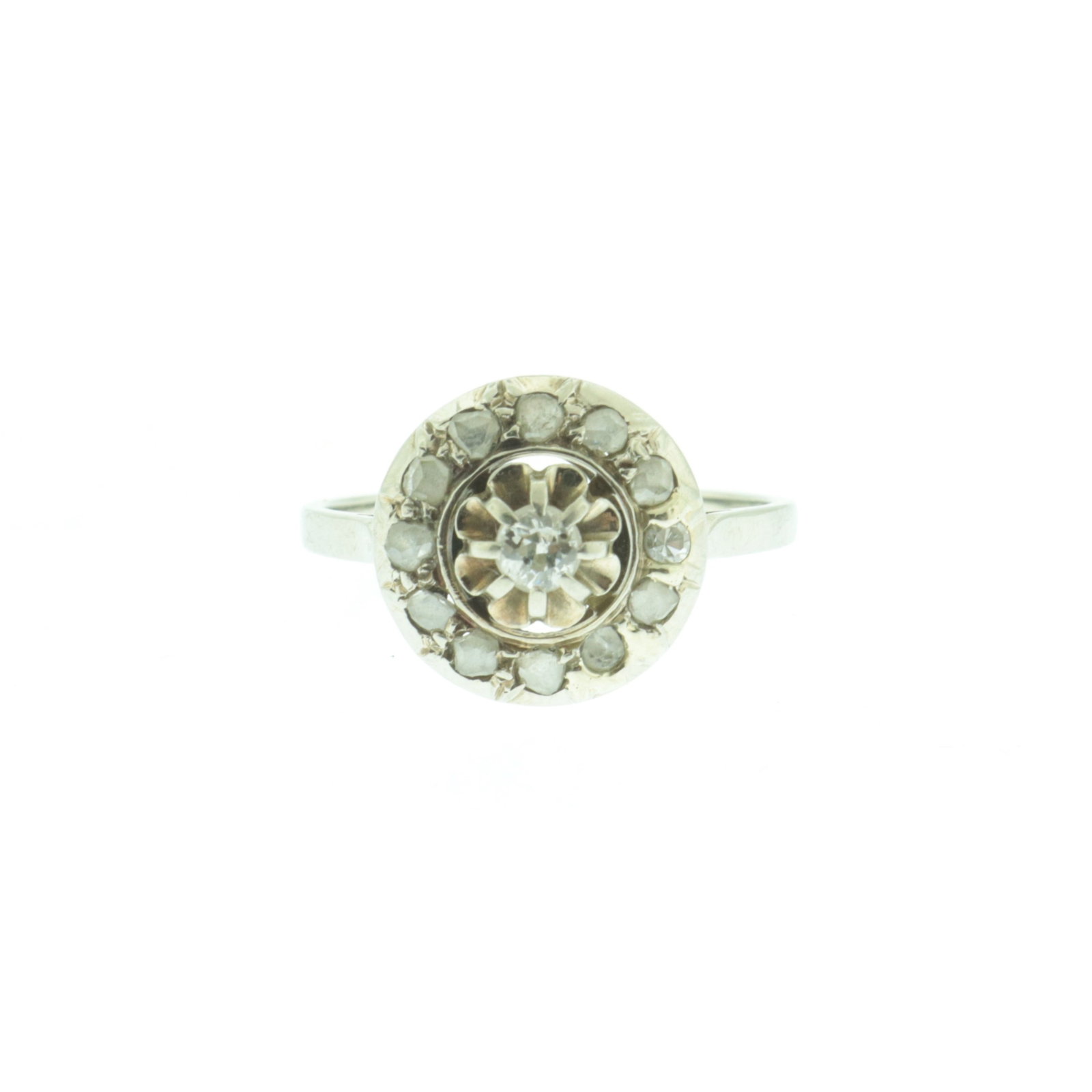 Antique French 18K and Diamond Ring: An antique French 18 karat white gold ring with central Old Mine cut diamond in floriform setting surrounded by halo of 12 single cut diamonds. Stamped with eagle head on outside shank. Gross weight o