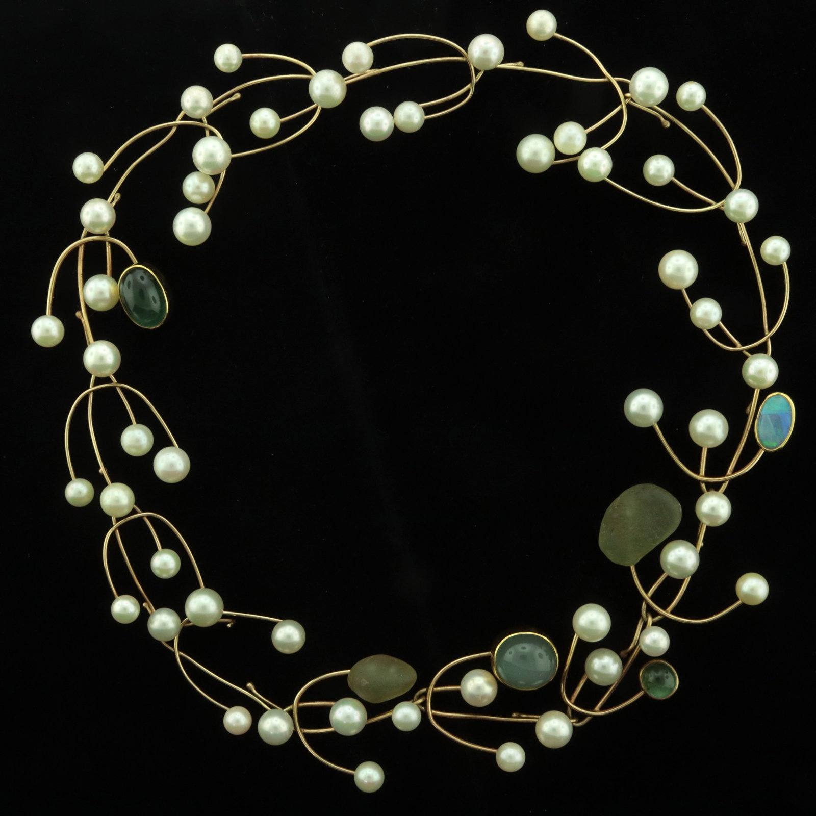 Betsy Fuller Gemstone and Wirework Necklace: Vintage Betsy Fuller necklace comprised of 15 interchangeable 14 karat yellow gold wirework links with cultured pearls, opal, sea glass, moonstone, and synthetic emerald cabochons. Signed. Gross