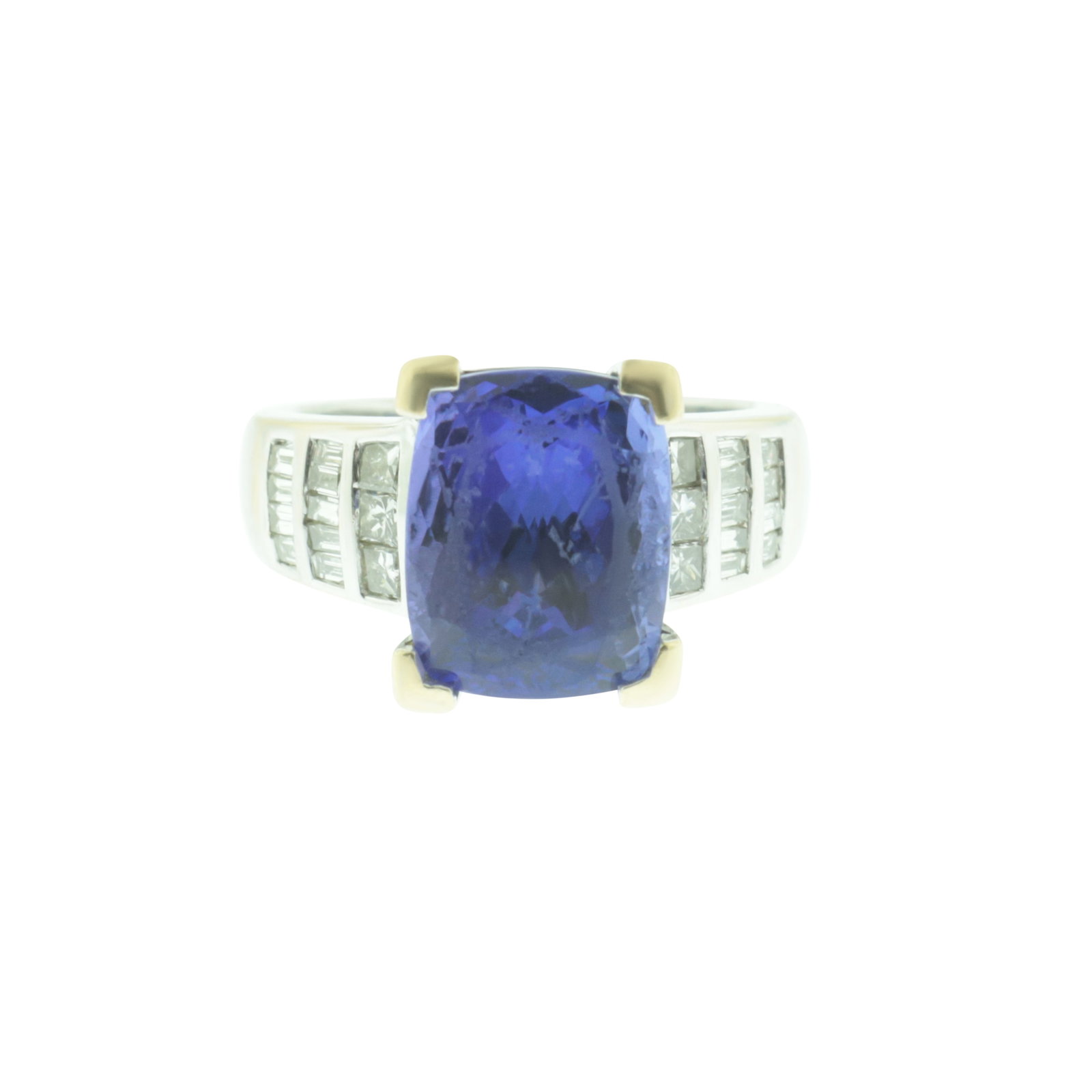 Tanzanite and Diamond Ring: A rectangular cushion cut tanzanite weighing approximately 5cts (11.41 x 9.21 x 6.72 mm) in yellow gold flat corner claw setting, flanked on each side by one row of three brilliant cut diamonds follow