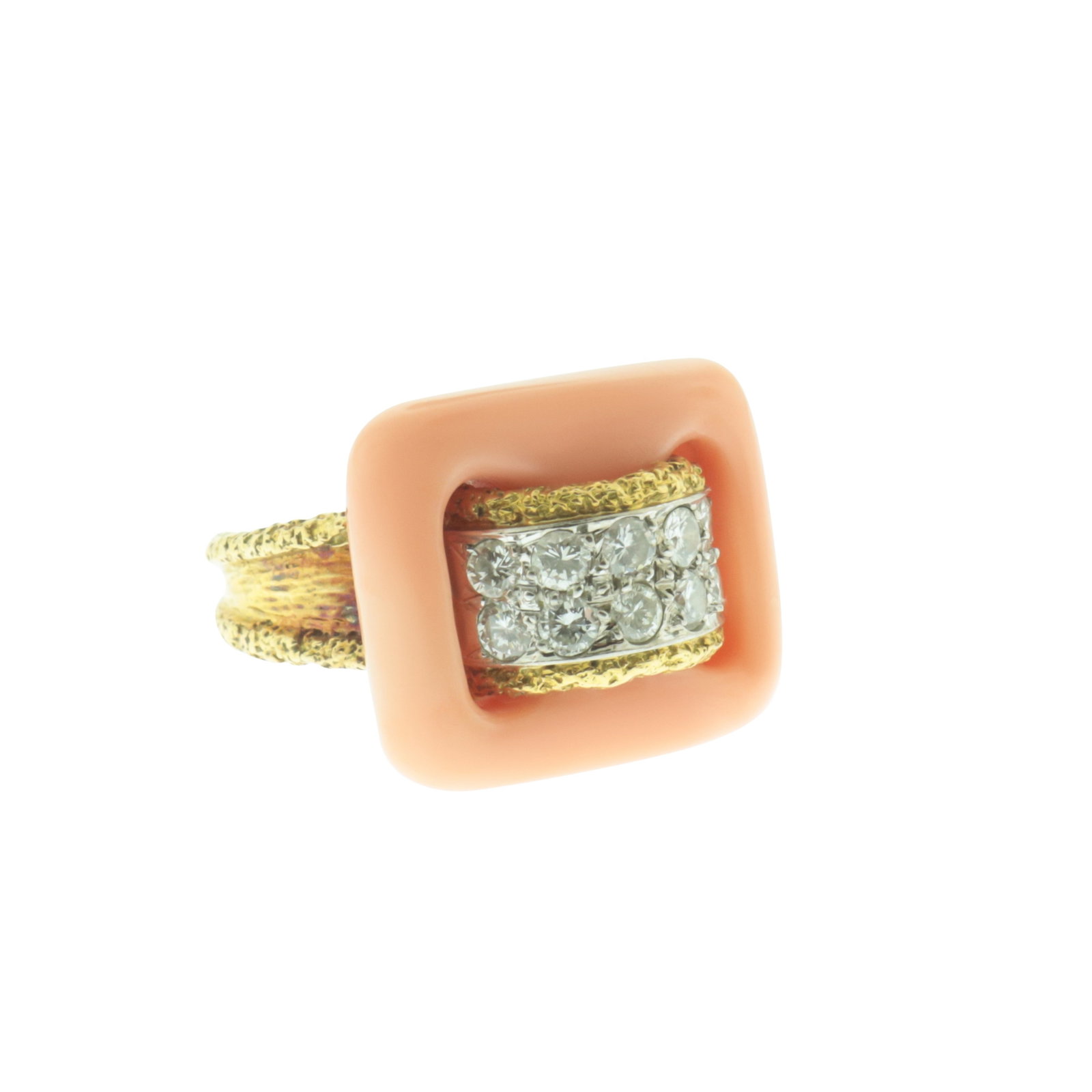 Van Cleef and Arpels Diamond & Coral Ring: A vintage Van Cleef and Arpels 18 karat textured yellow gold ring with carved angel skin coral 'buckle' centered by 10 diamonds weighing approximately 0.65 cts, circa 1970. Signed Van Cleef & Arpels, 