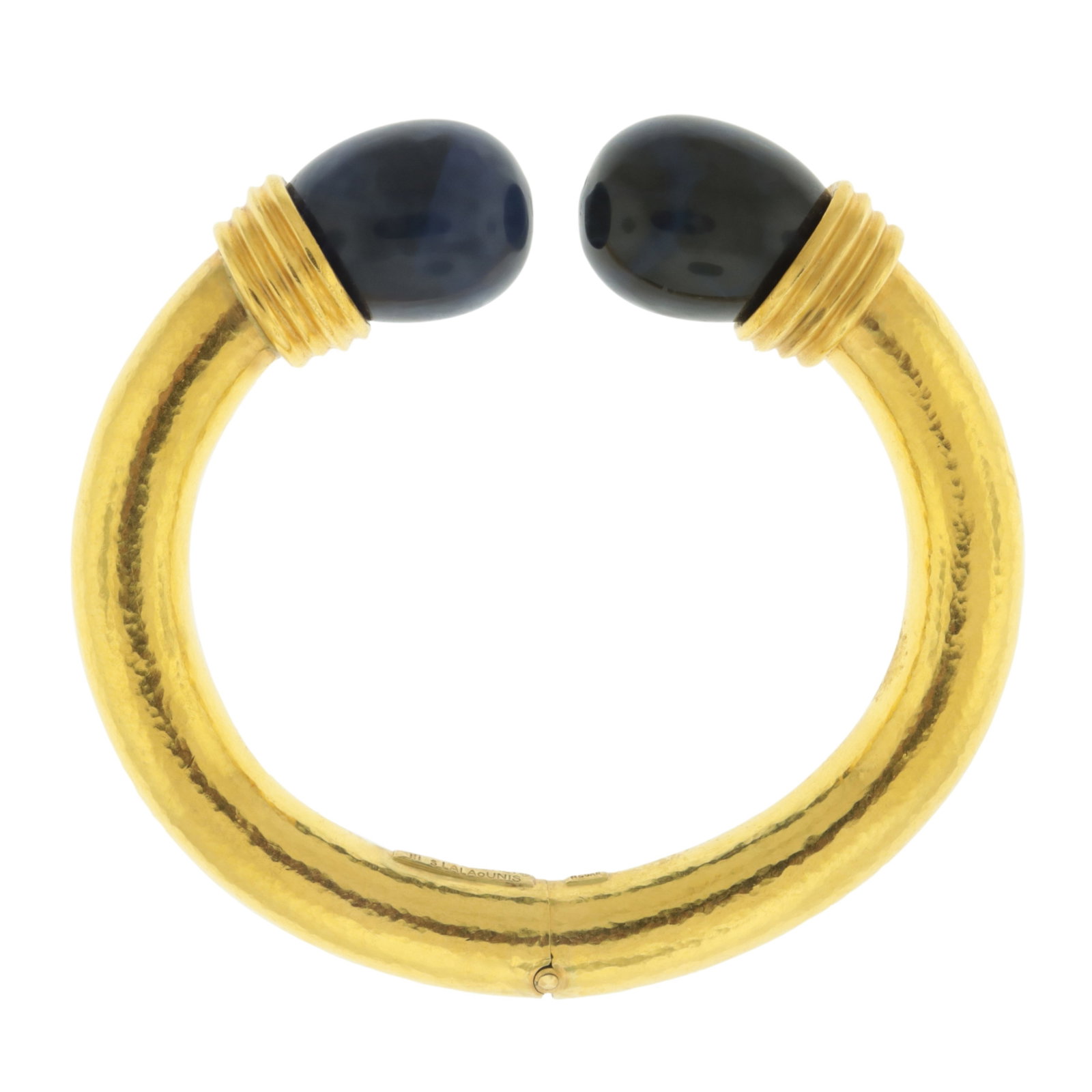Lalaounis 18K and Sodalite Cuff Bracelet: Ilias Lalaounis, Greece, 18 karat hammered yellow gold cuff bracelet ending with sodalites. Hinged center. Stamped 750, Greece, A21, maker's mark, Ilias Lalaounis, Mecan. Gross weight of 63.4 grams. I