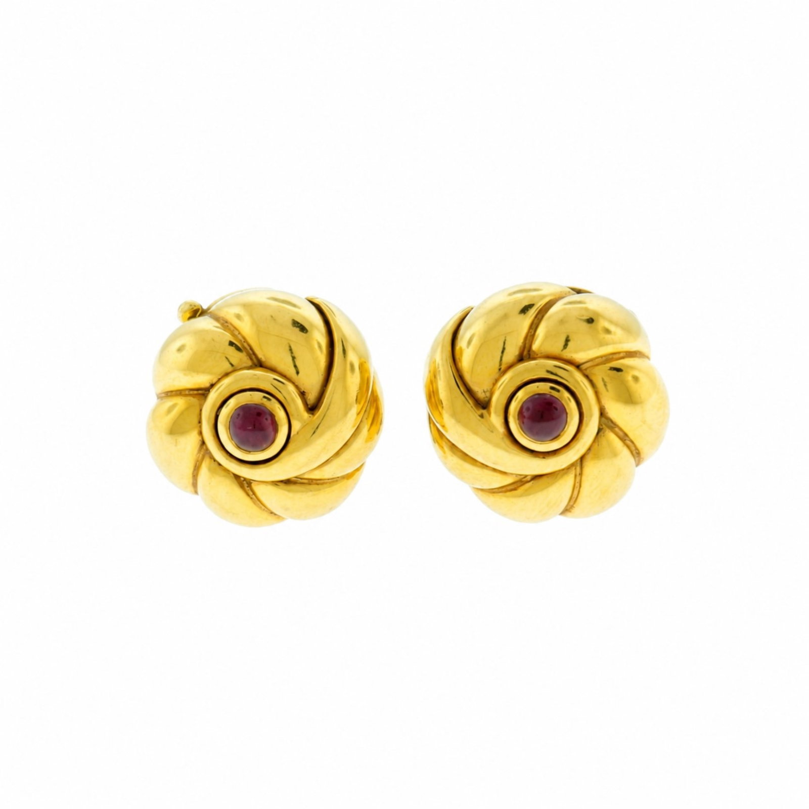 Pair of Van Cleef and Arpels 18K Swirl Earrings: A vintage pair of Van Cleef and Arpels 18 karat yellow gold swirl-form clip earrings centered with cabochon ruby. Back stamped VCA 750. Clip stamped NY3T9257. Gross weight of 20.5 grams. 5/8" diameter
