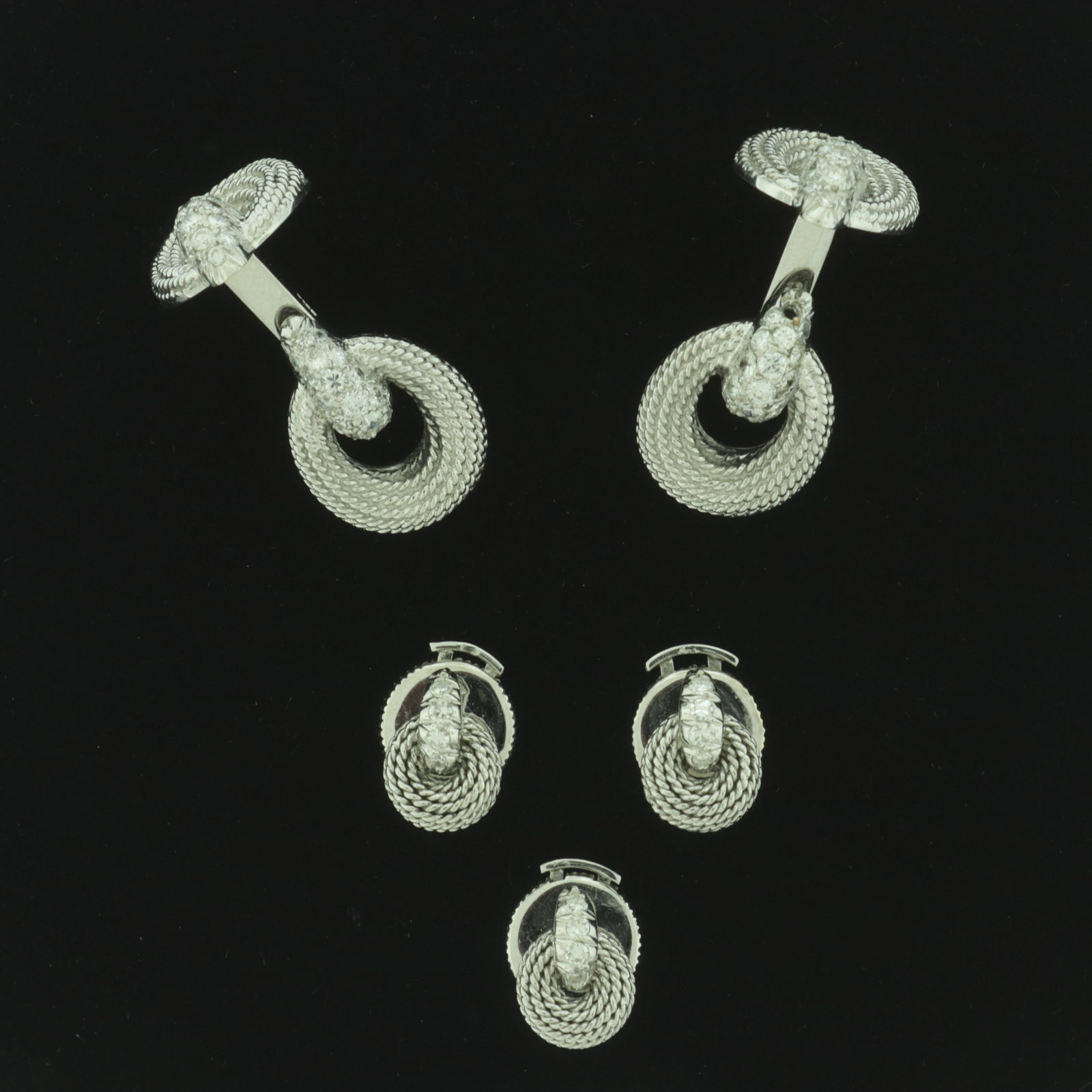 Sterle 18K and Diamond Cufflinks & Shirt Studs: Sterle Paris 18 karat white gold and diamond adorned rope motif cufflinks and three shirt studs. Cufflinks containing 63 round melee diamonds (32 and 31 each), studs containing four. Signed Sterle Par