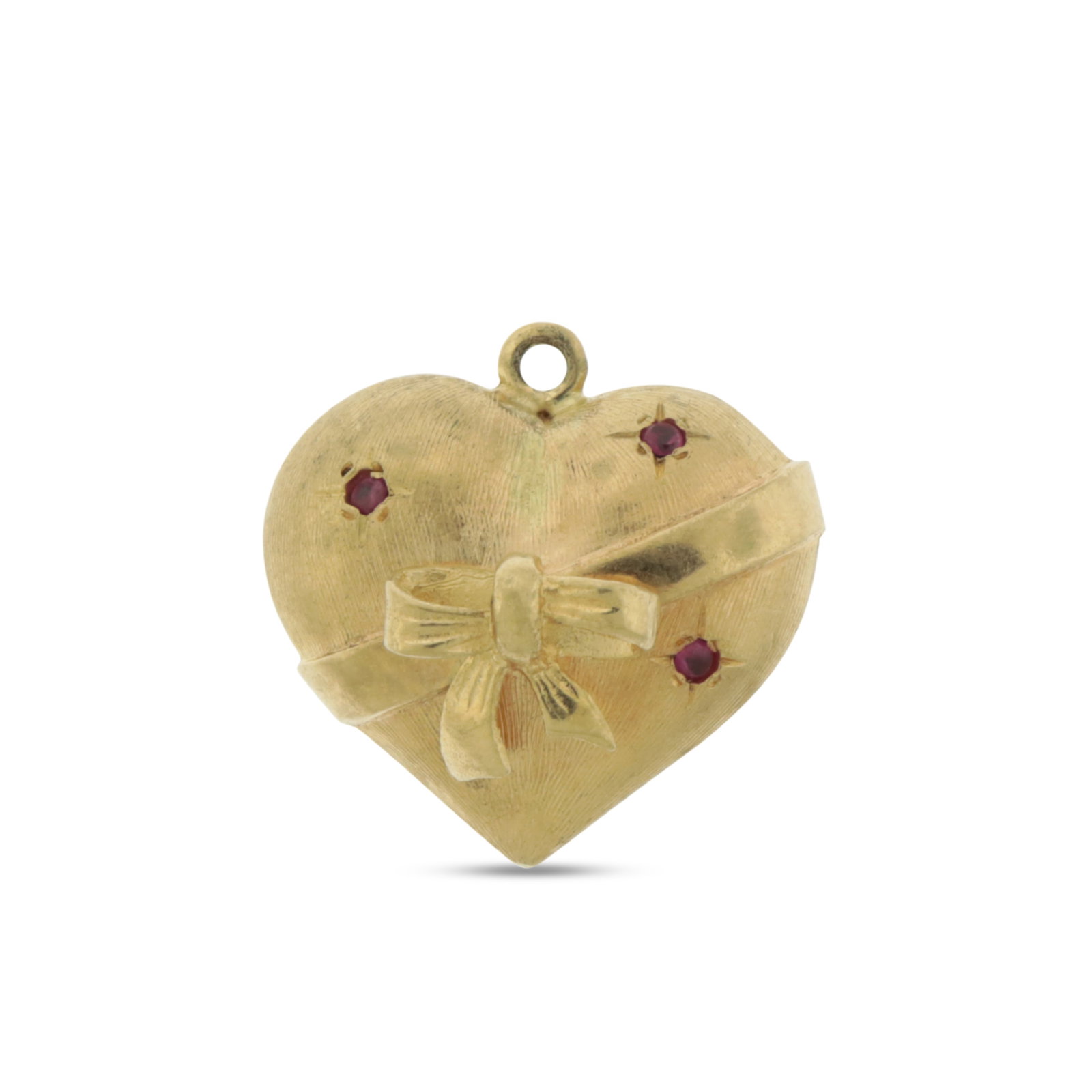 14K Gold Heart Shaped Charm: A 14 karat yellow gold solid heart form charm, wrapped with a bow, adorned with three small rubies. Acid tested, weighing 9.0 grams. 1" x 1" Property from a Connecticut collection.