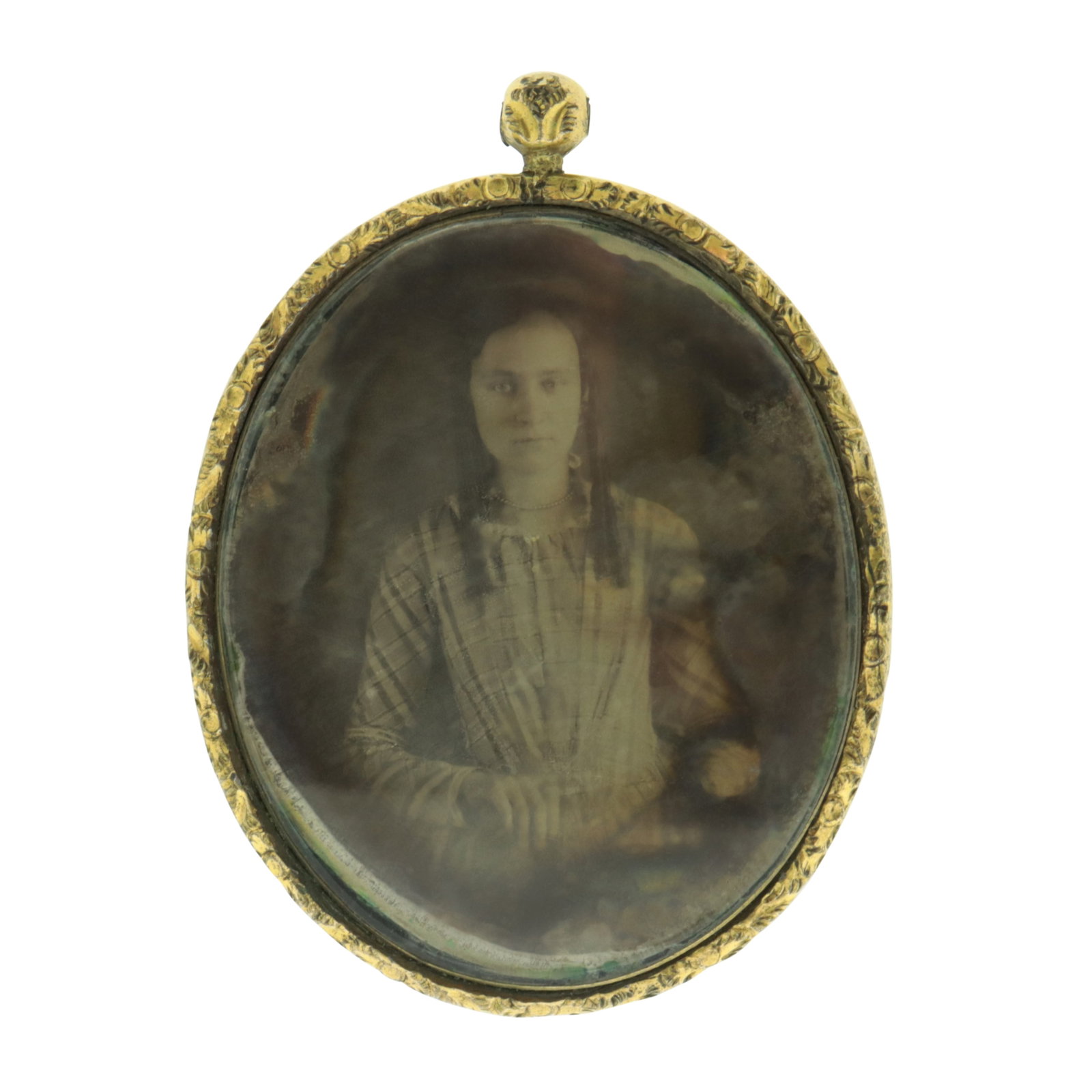 Victorian Mourning Pendant: A rolled gold Victorian mourning pendant with seated portrait daguerreotype of a woman with long hair, verso with chased design and enclosed lock of hair. 2 3/8" x 1 3/4" Property from a Connecticut
