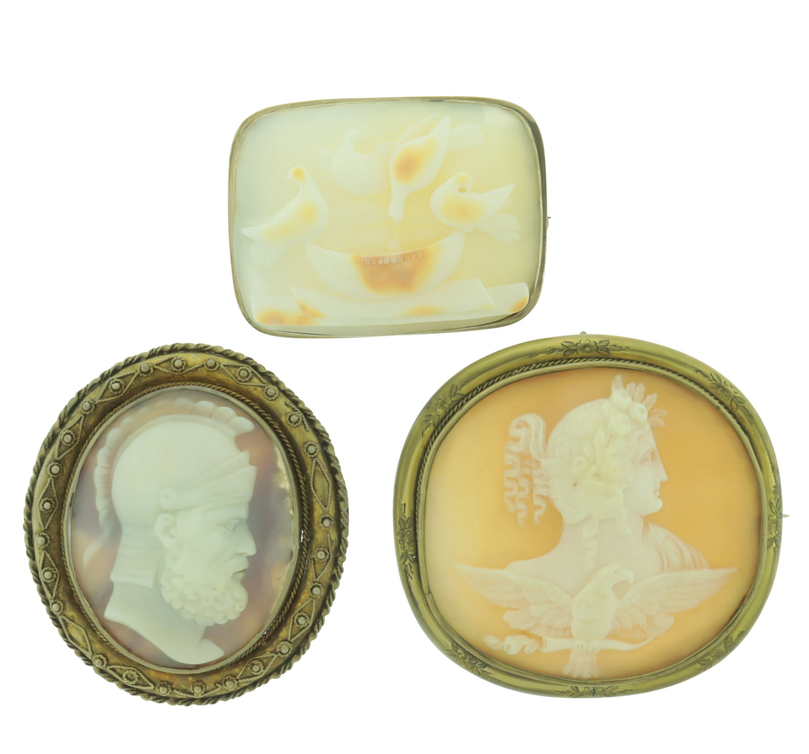 Three Antique Cameos: A group of three late 19th to early 20th century cameos comprising: Doves of Pliny carved shell cameo, Aphrodite carved shell housed in floral chased frame (possibly pinchbeck), and profile of