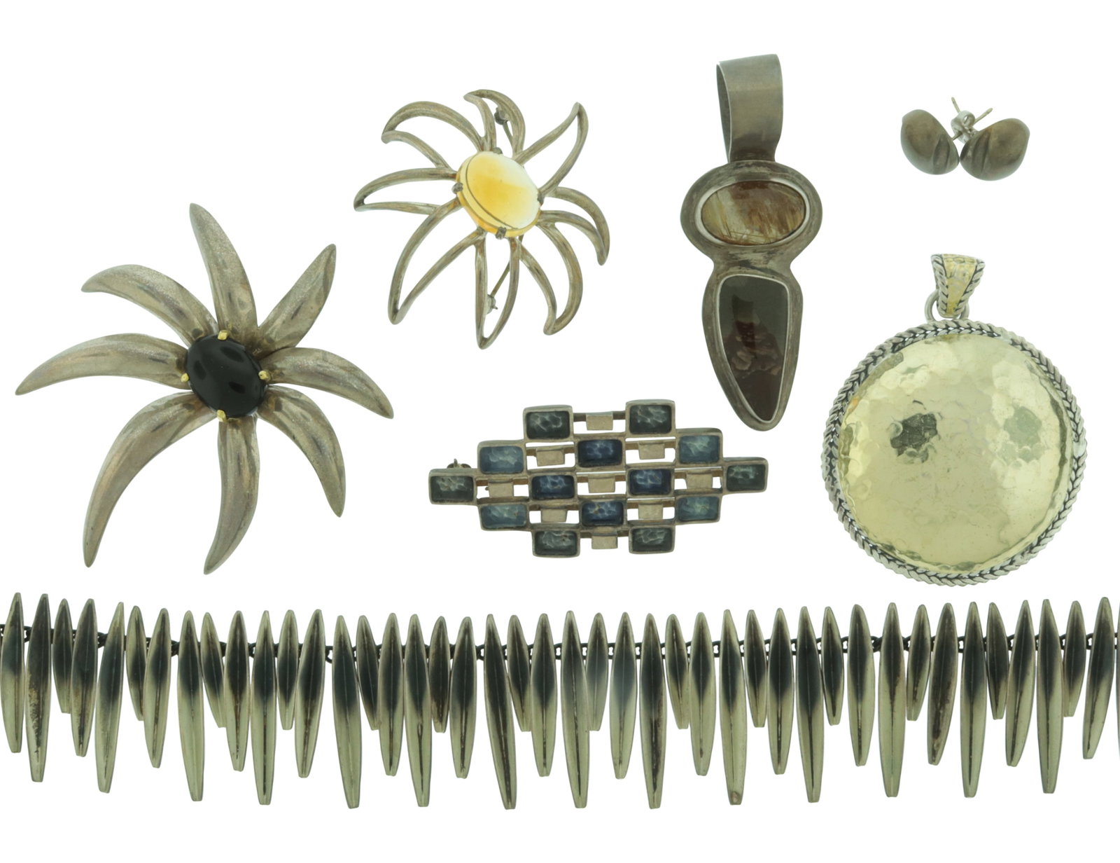 Group of Sterling Silver Jewelry: A grouping of vintage sterling silver jewelry. Comprising: Tiffany & Co 'Fireworks' sterling silver and 18k yellow gold brooch with onyx cabochon center, Tiffany & Co 'Fireworks' sterling silver open 