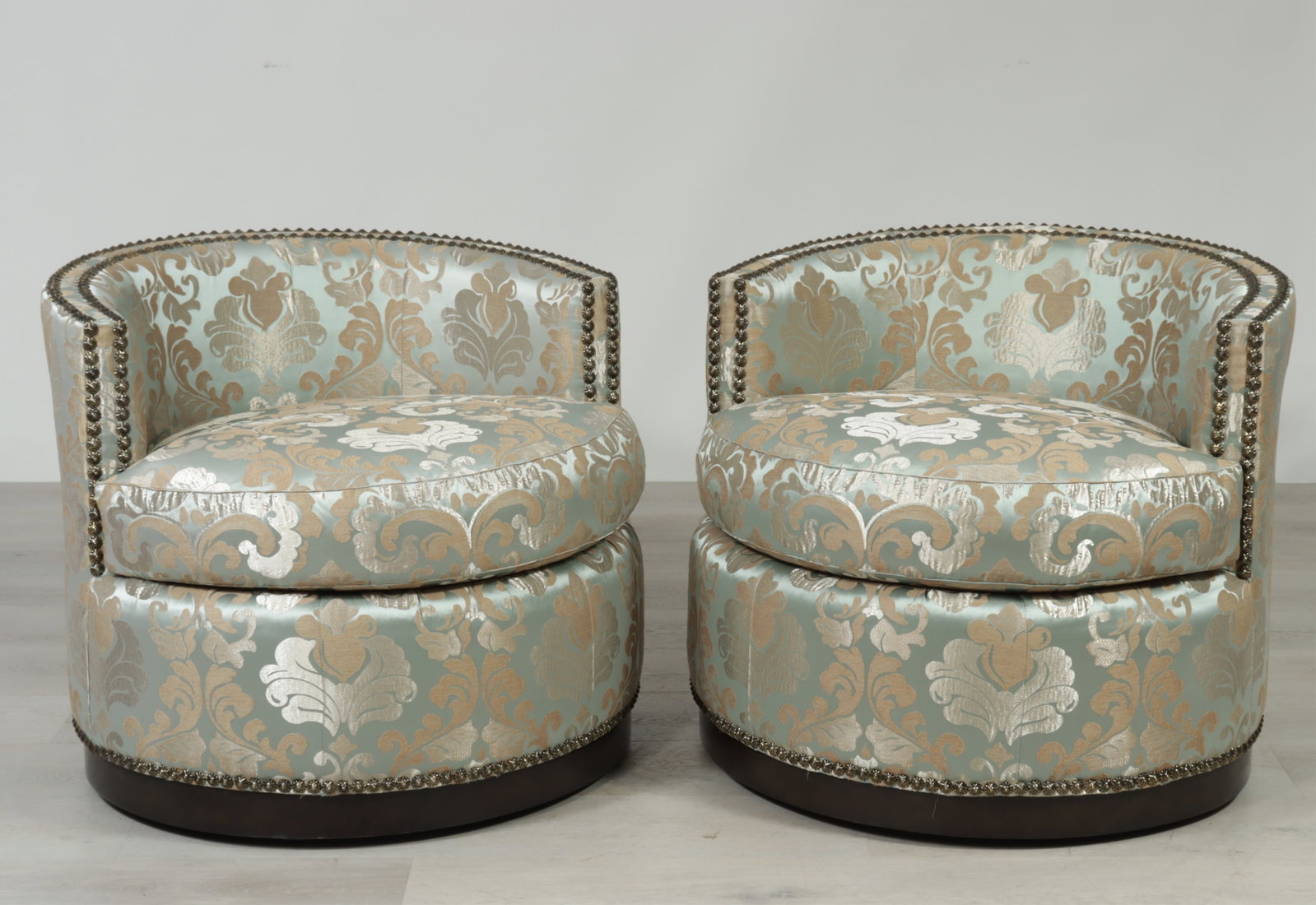 Pair of Marge Carson Martini Chairs: Pair of Marge Carson 'Martini' swivel tub chairs, in brass tacked embroidered blue fabric upholstery. 32"W x 32"D x 33"H