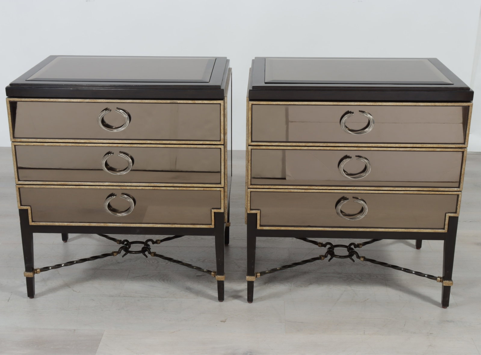 Pair Marge Carson Bolero Side Tables: Pair of Marge Carson Bolero smoked mirror & walnut stained three-drawers commodes. 31.25" H x 29" W x 20" D