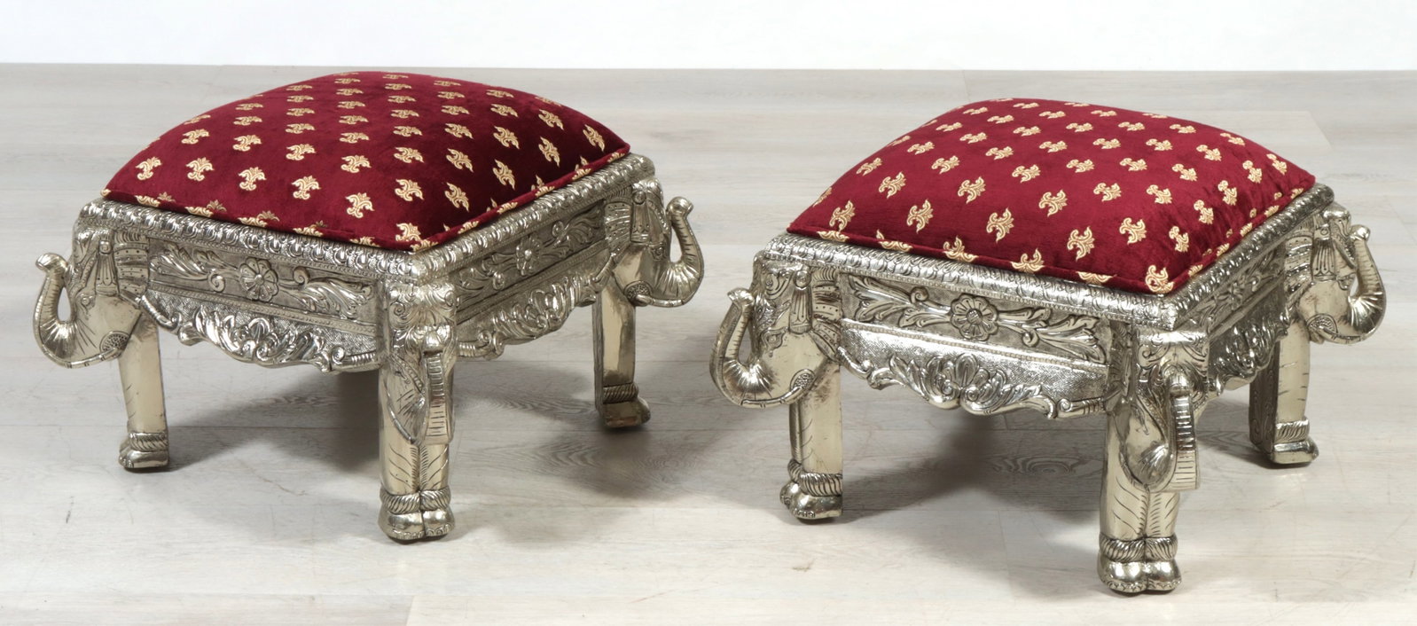 Pair Indian Repousse Brass Veneered Stools: Pair Indian Repousse Brass Veneered Stools, elephant feet, upholstered in burgundy brocade 16' H x 21.5" Square