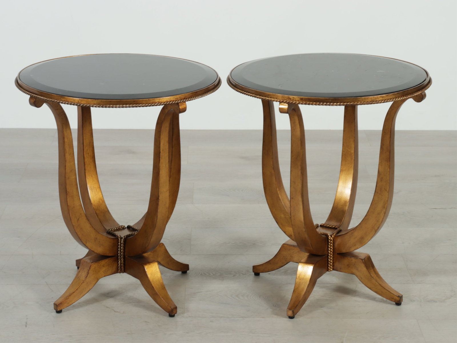 Pair of Marge Carson Deco Side Tables: Pair of Marge Carson 'Deco' gold finished side tables with black tessellated marble tops. 24" H x 21" Dia.