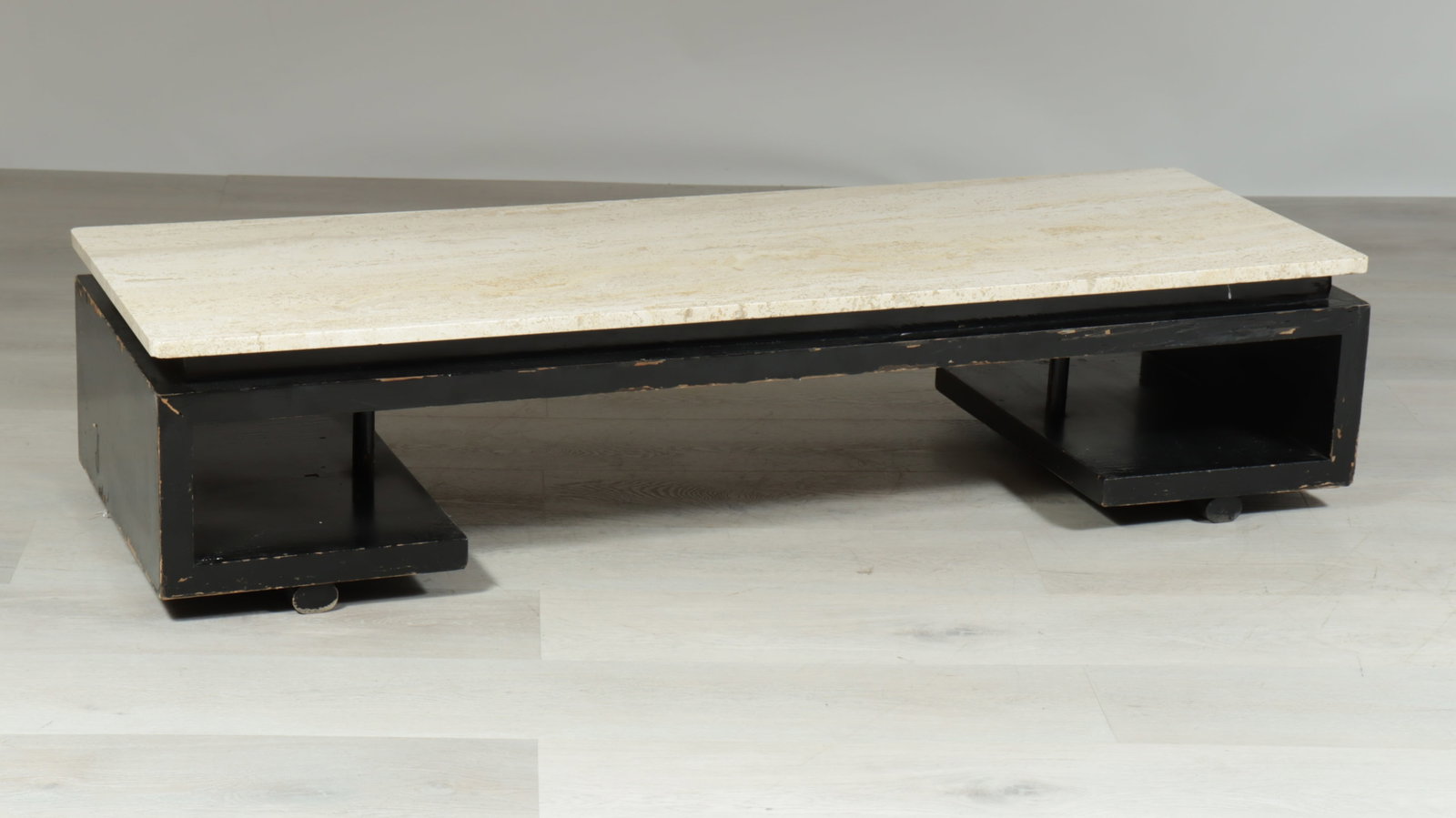 After Paul T Frankl Coffee Table: After Paul T Frankl model no. 5020, c.1950, coffee table base, black painted wood veneer, travertine top, underside of top marked made in Italy Base 12.5 x 60 x 20, Top 60 x 20 x 20, Overall 13.25