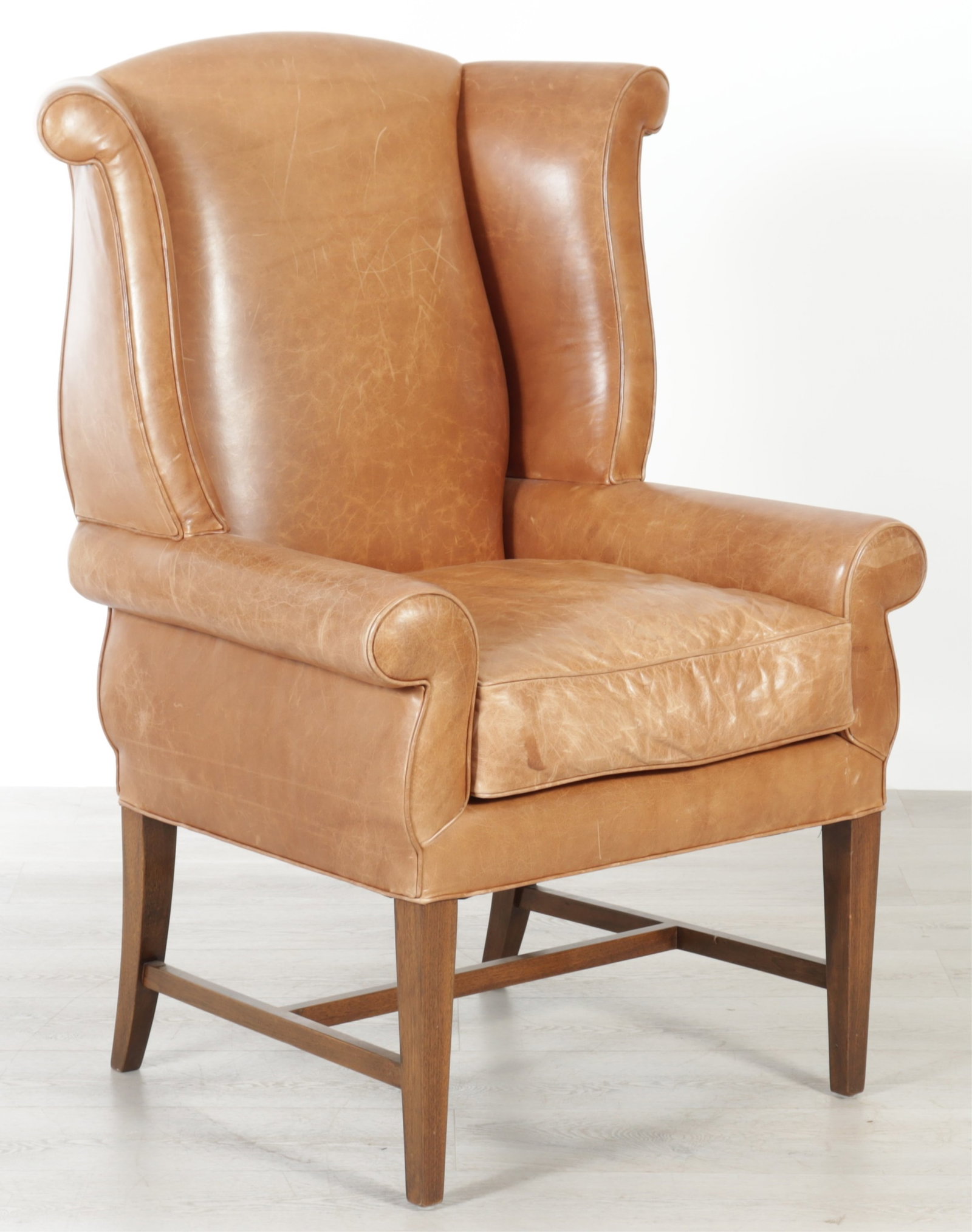 Posse Leather and Mahogany Wing Armchair: George III style mahogany wing armchair by Posse Furniture LA, upholstered in brown leather. 46.5" H x 36" W x 30" D