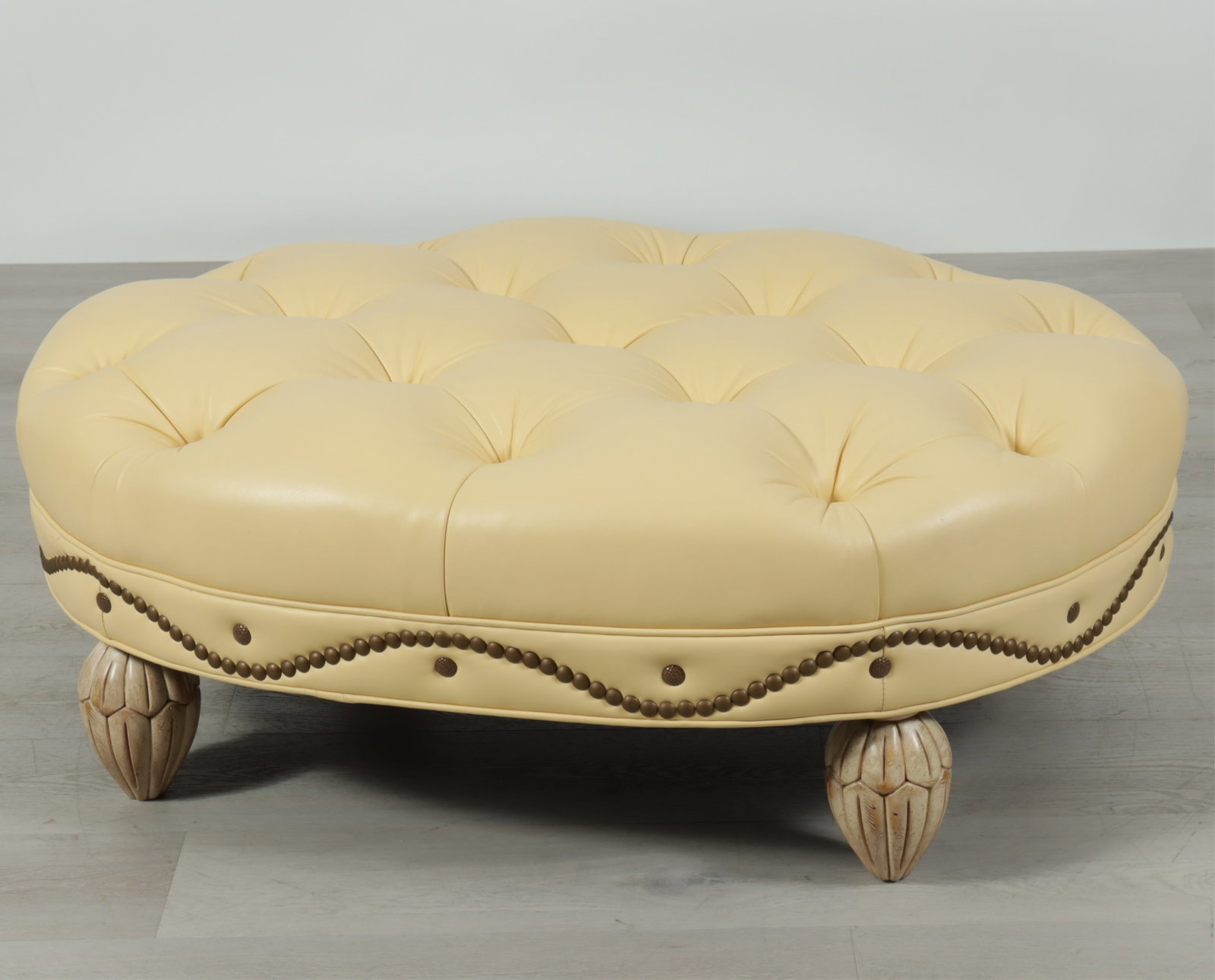 Kravit Art Deco Style Ottoman: Kravit art deco style ottoman upholstered in tufted yellow brass tacked leather. 16" H x 45" W x 35" D