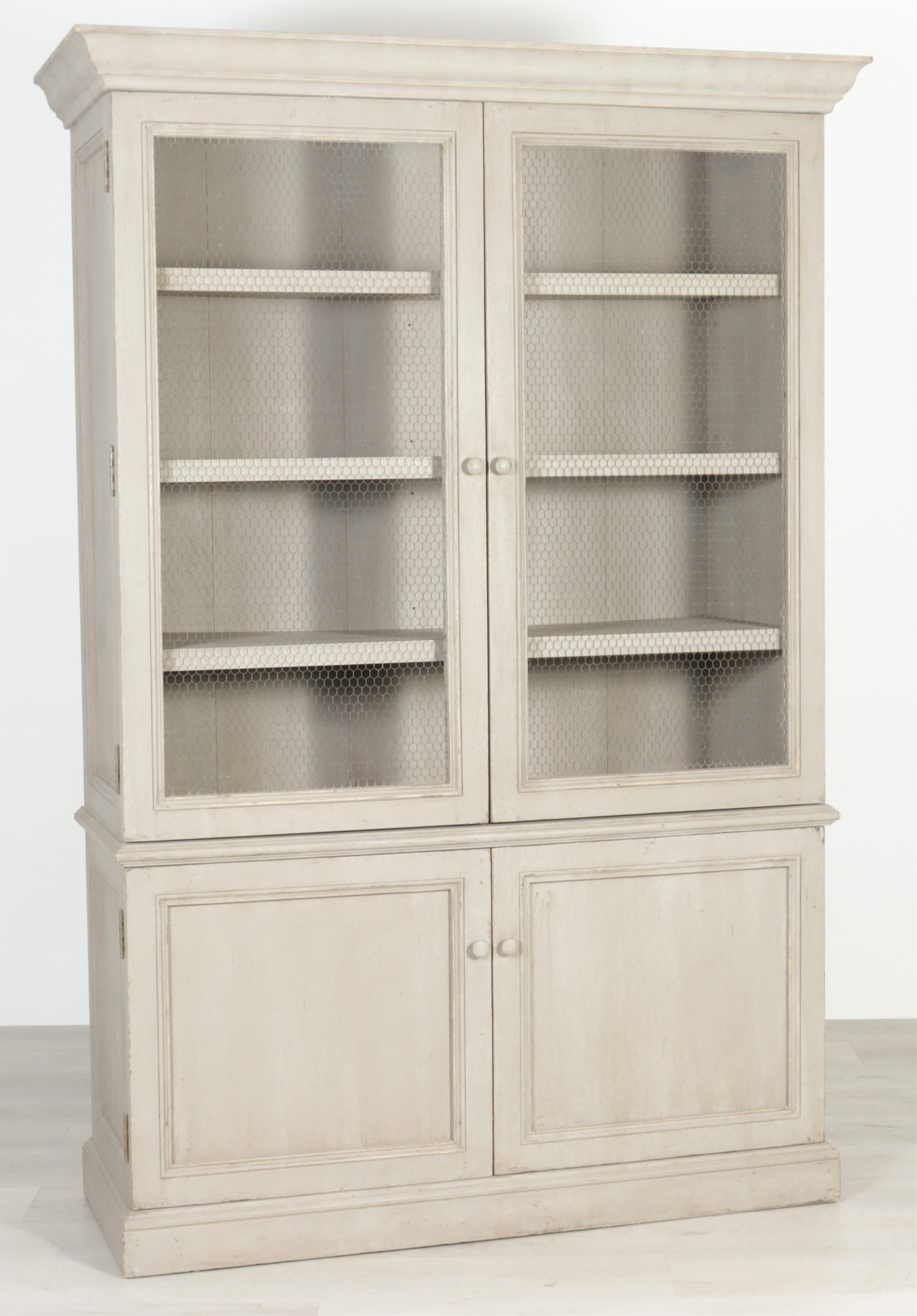 Swedish Classical Style Grey Painted Bookcase: Swedish Classical style grey painted bookcase with three shelves enclosed by wire mesh doors, over double door cabinet section. 84" H x 57.25" W x 22.25" D