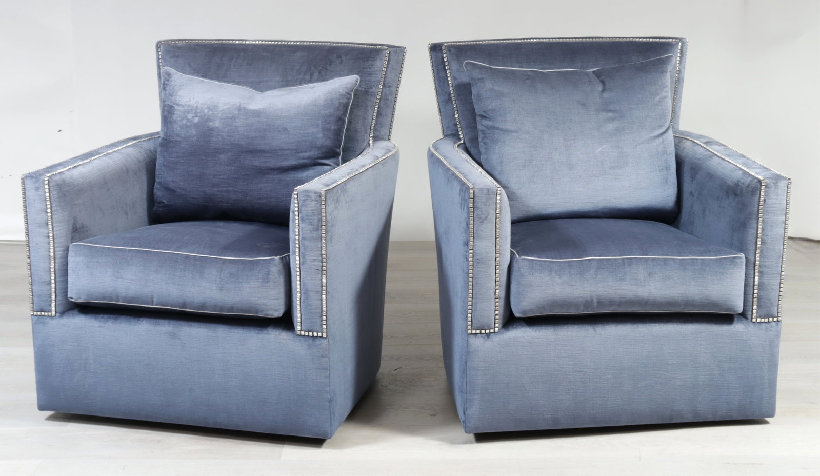 Pair Marge Carson Santa Barbara Armchairs: Pair Marge Carson Santa Barbara swivel armchairs upholstered in a rhinestone tacked blue velour. 38.25" H x 33" W x 39" D