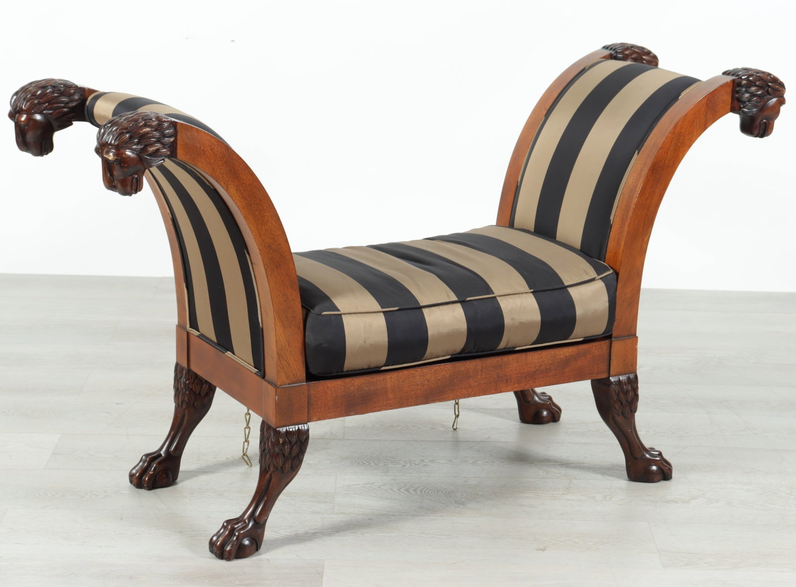 Baker Classical Style Window Bench: Baker Classical Style Mahogany Window Bench, with lion's mask, upholstered in gold & black striped fabric 32" H x 56" W x 19" D