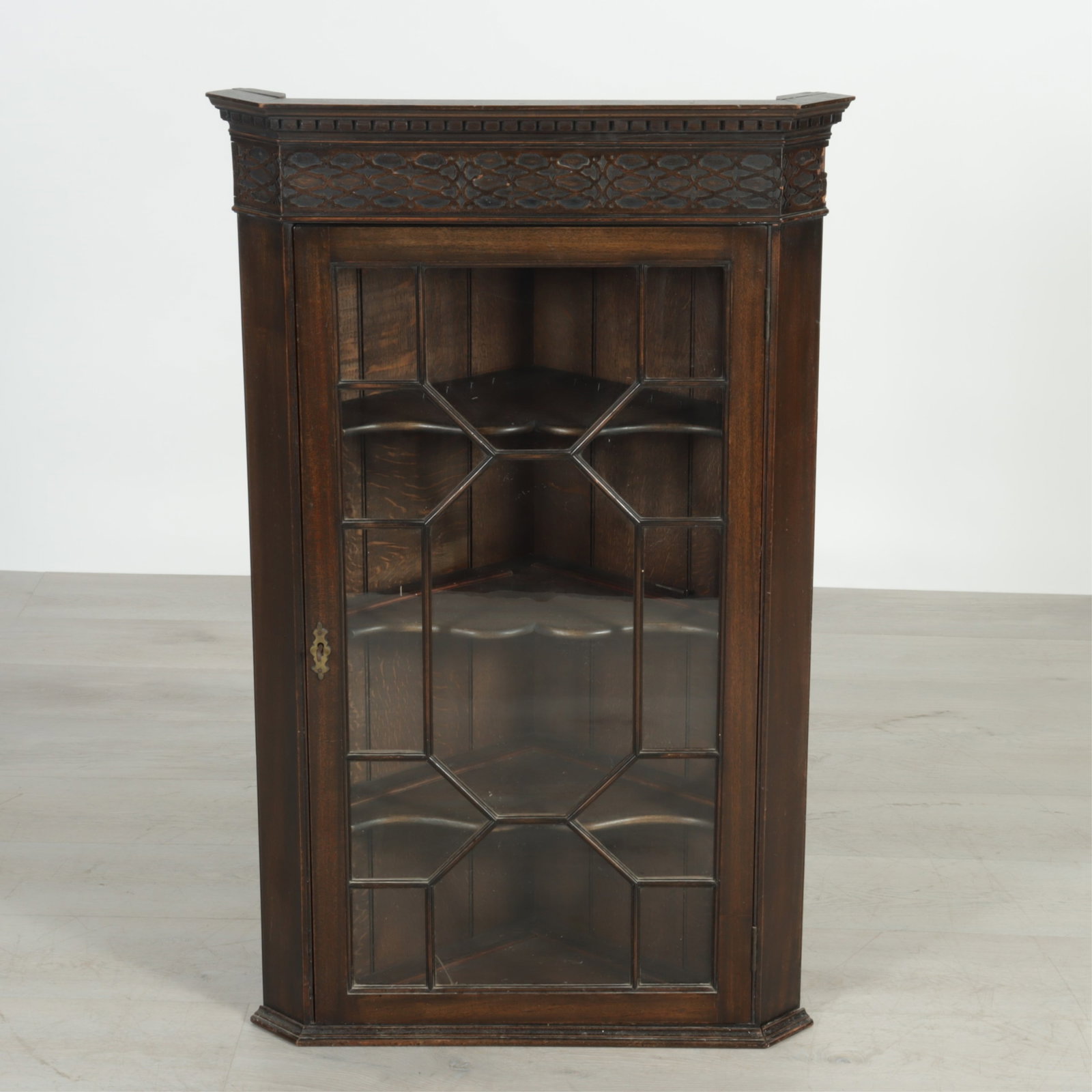George III Style Mahogany Hanging Corner Cabinet: George III Style Mahogany Hanging Corner Cabinet, blind fret frieze, mullioned door 40.75" H x 25.5" W x 13.5" D