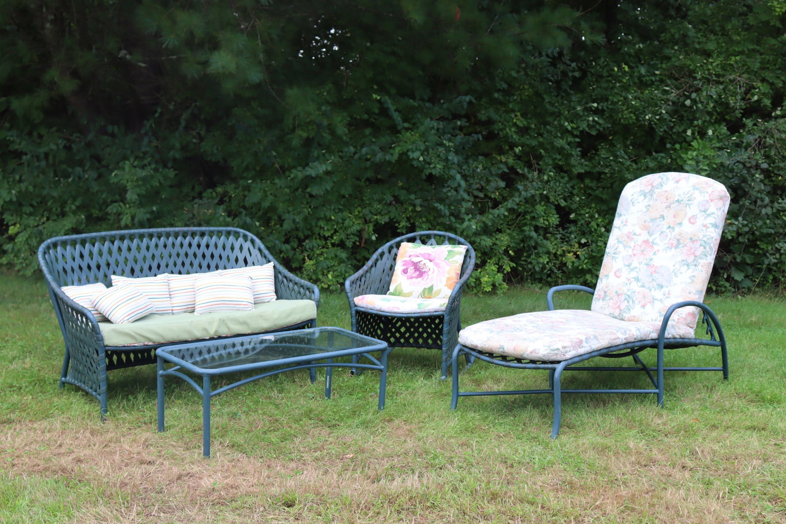 Brown Jordan Outdoor Lounge Furniture: Brown Jordan outdoor lounge furniture, includes sofa, cocktail table, rocking chair and adjustable chaise lounge with various floral and striped cushions. Sofa 32 H x 49 W x 29 D; Cocktail table 16 H 
