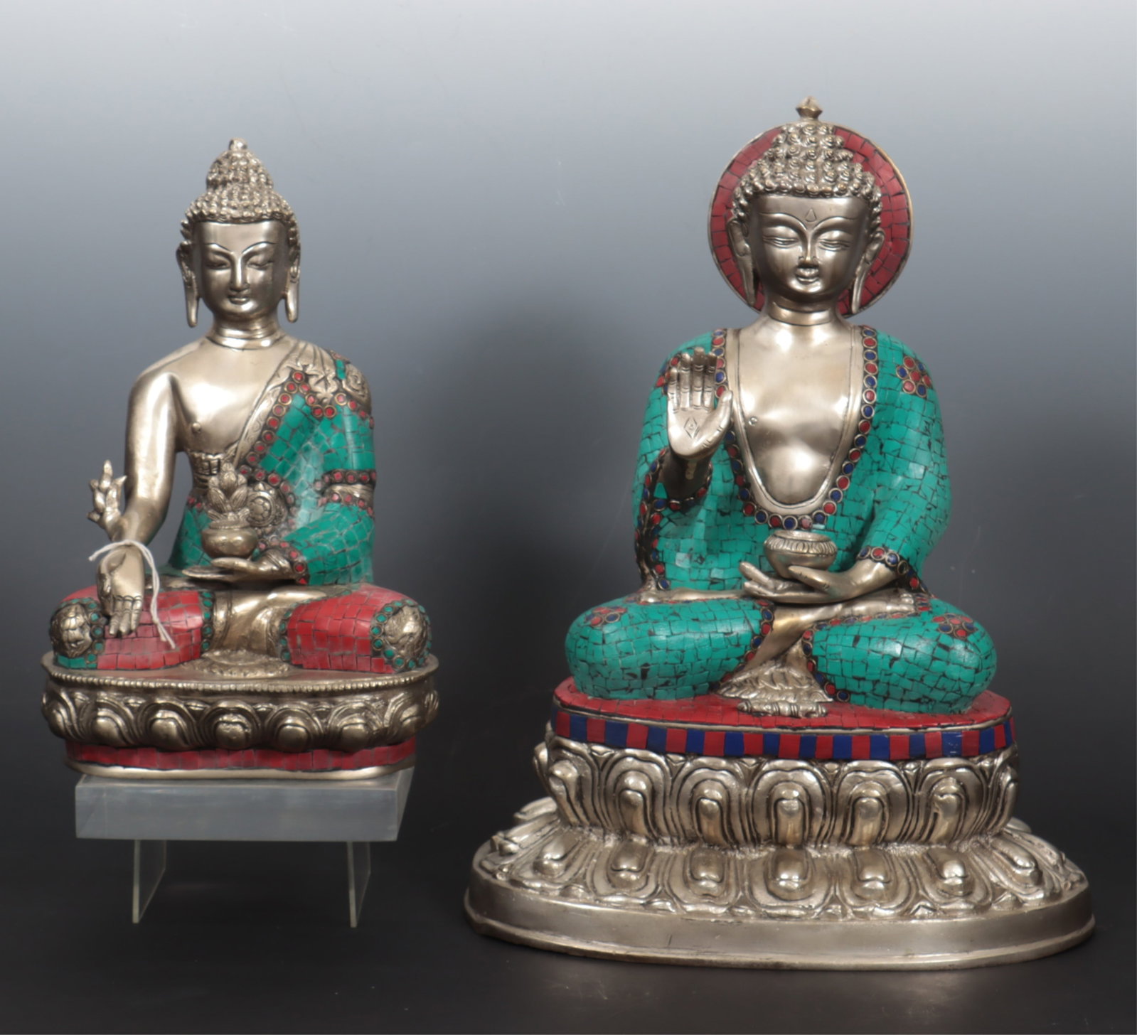Two Indian Faux Stone & Brass Seated Buddhas: Two Indian Faux Stone & White Brass Seated Buddhas, decorated with faux lapis, malachite and coral. Larger 16" H