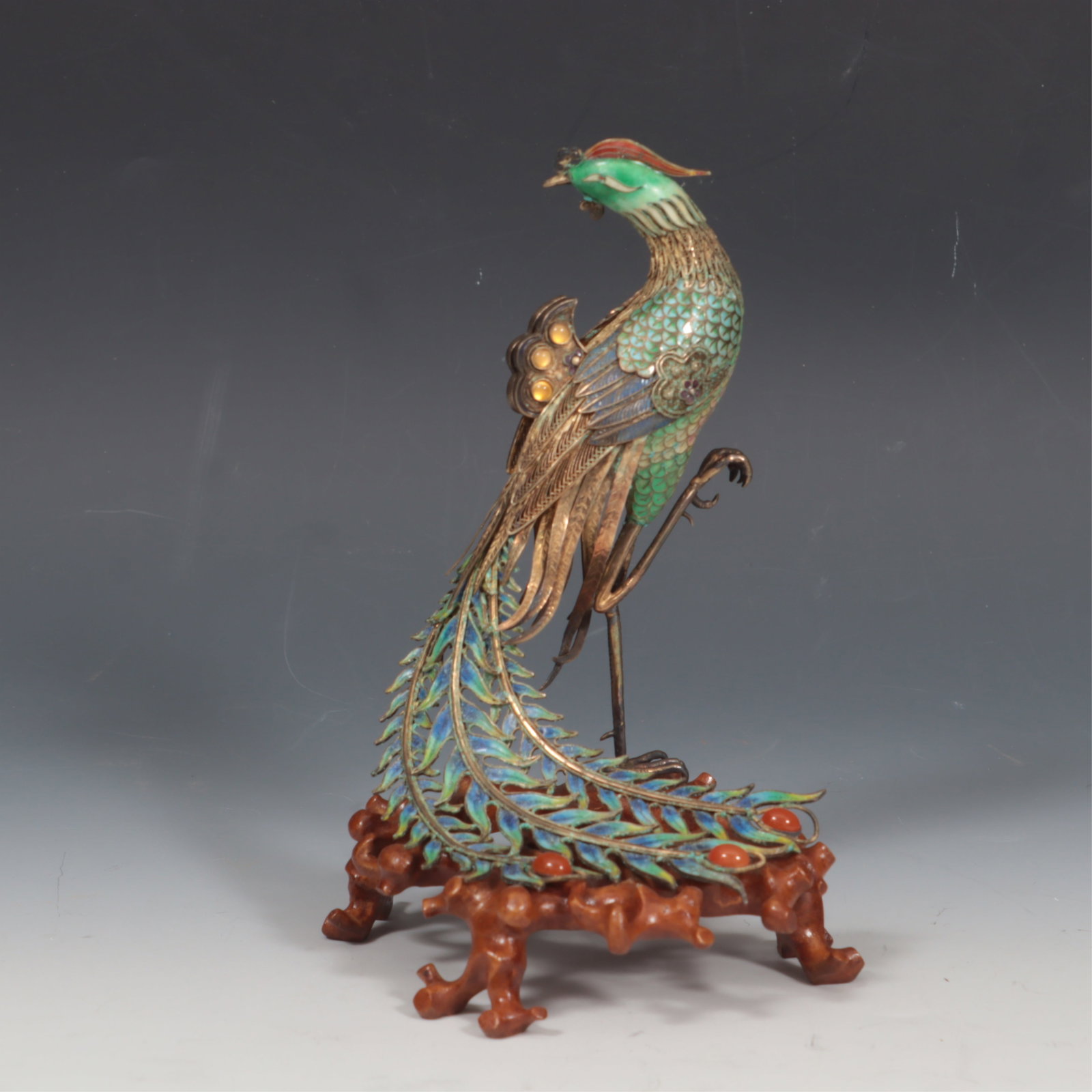 Chinese Sterling Silver and Cloisonne Phoenix: Chinese Export gilt sterling silver filigree, Cloisonne enamel phoenix/peacock on wooden branch form stand, accented with carnelian cabochons 7.5 x 5.25