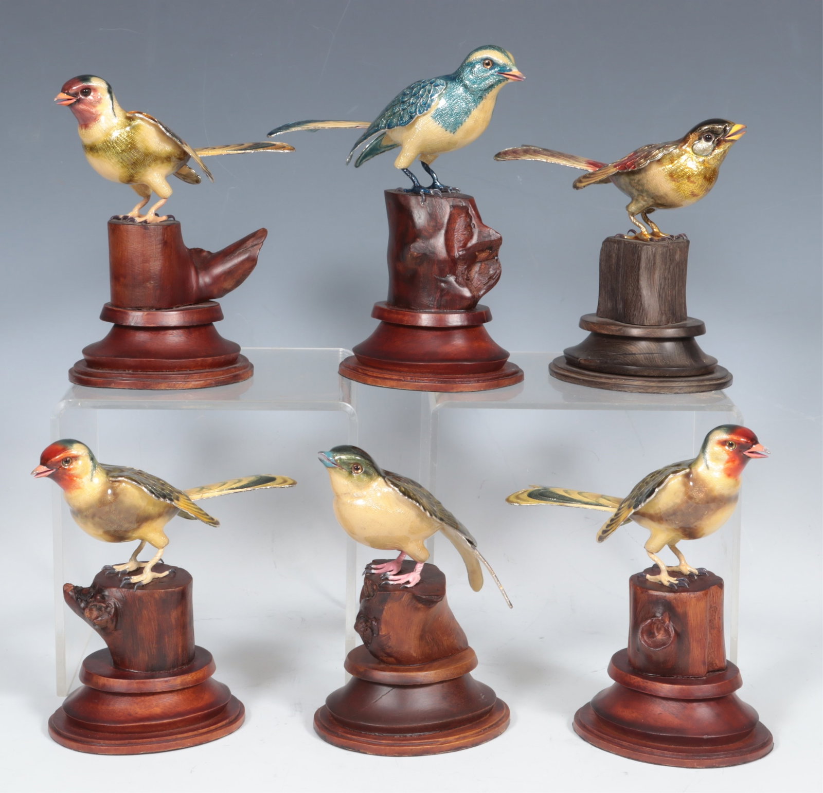 Six Indian Enameled Copper Birds: A group of six various Indian enameled copper birds on wooden stands including ultramarine, house martin, leiothrix & finches. Largest 7" H