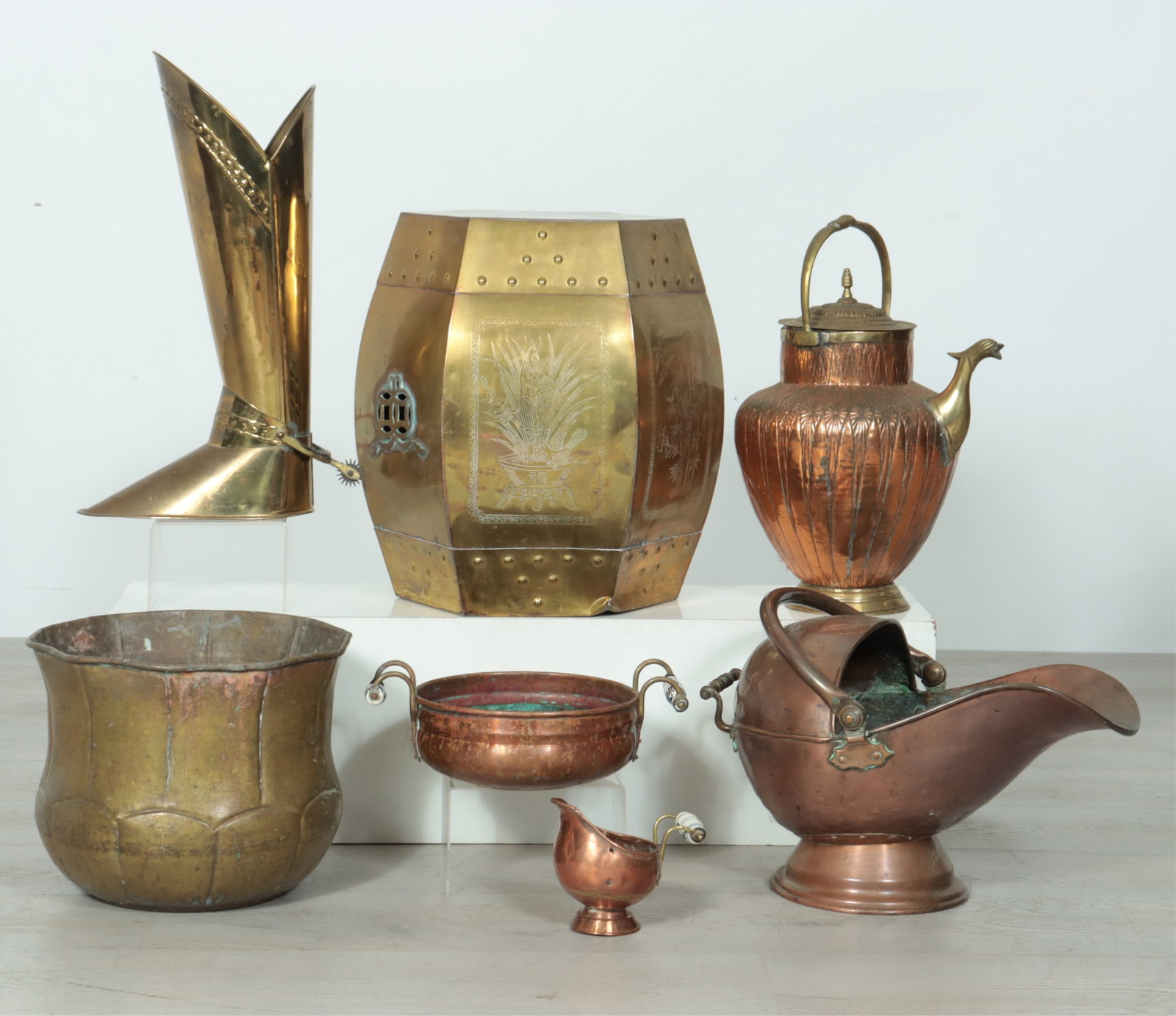 Asian & European Copper and Brass Objects: 19th - 20th C. Asian and European brass and copper objects, includes a c.1970 Hollywood Regency Asian style brass garden seat/side table with chased designs, a tall brass boot, marked Made in England,