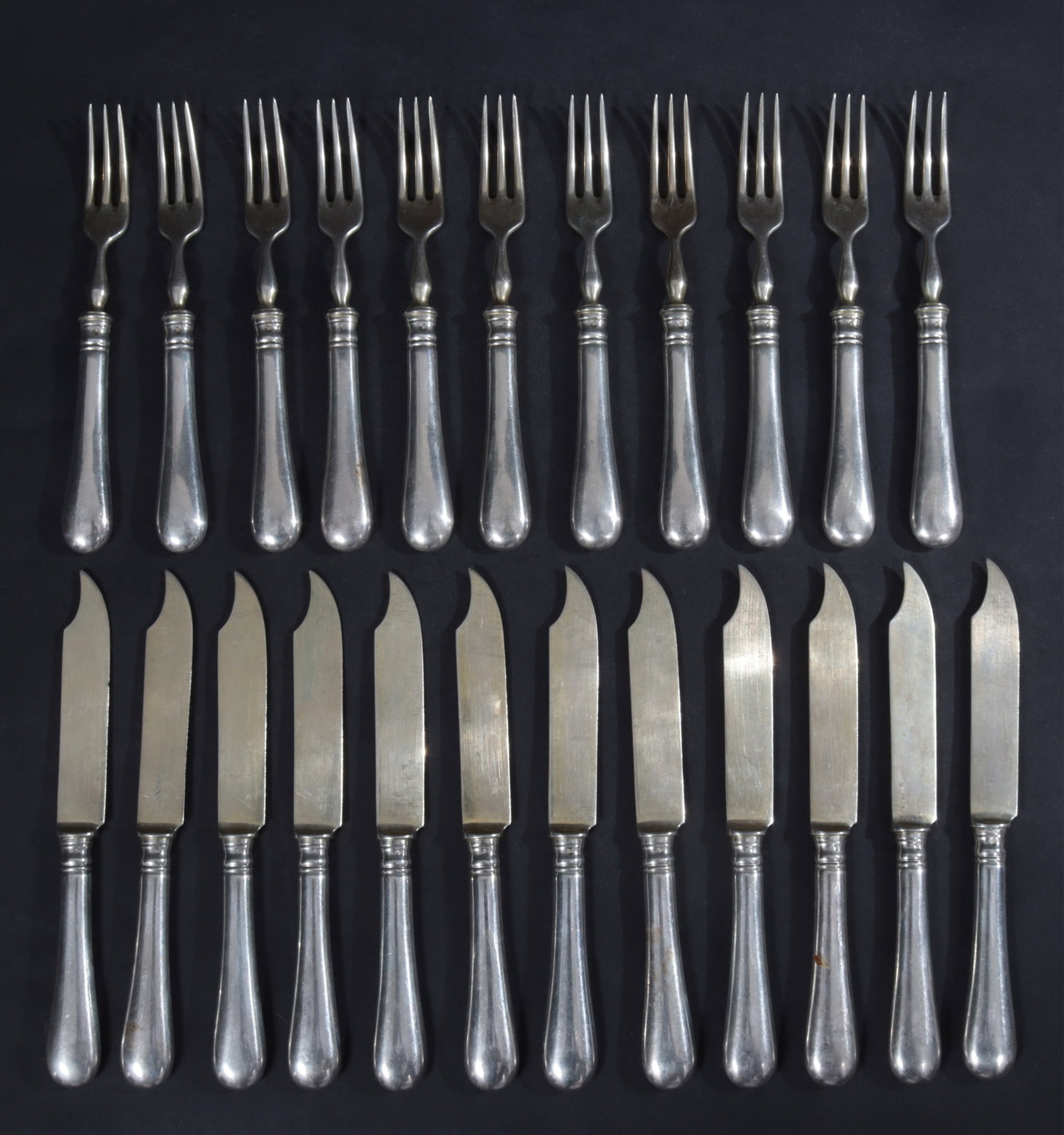 Jarosinski & Vaugoin Austrian Silver Flatware: Jarosinski & Vaugoin, Vienna, Austria, late 19th century .800 silver flatware. Comprising: 11 forks and 24 vermeil knives. Struck with Diana and chalice maker's mark. 27 OZT. 6.5" long and 7" long