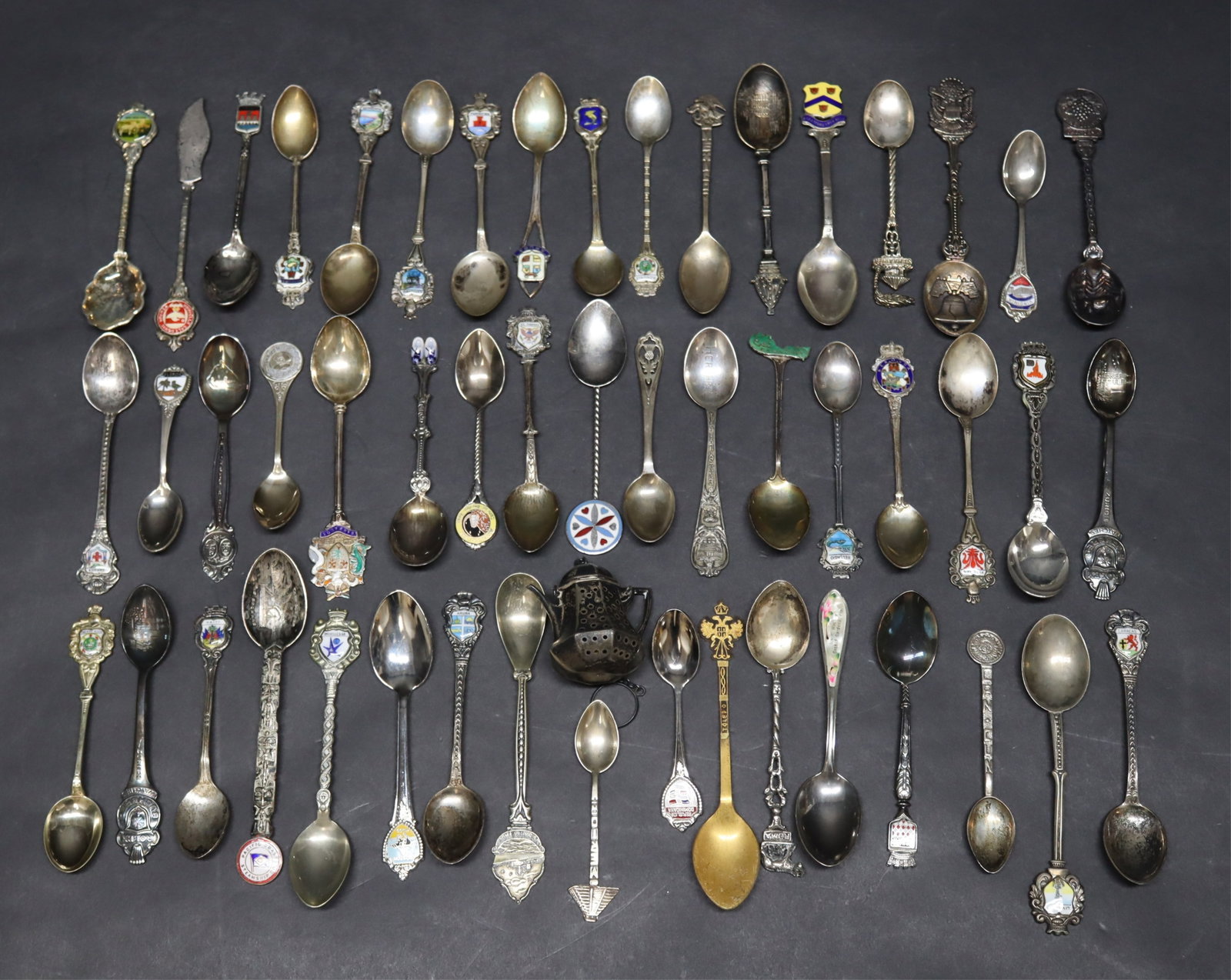 Souvenir Spoons, Sterling Silver and Plated: Collection of 51 sterling silver and silverplate souvenir spoons along with a sterling silver tea sieve, total weight 9 ozt. up to 4.5" length