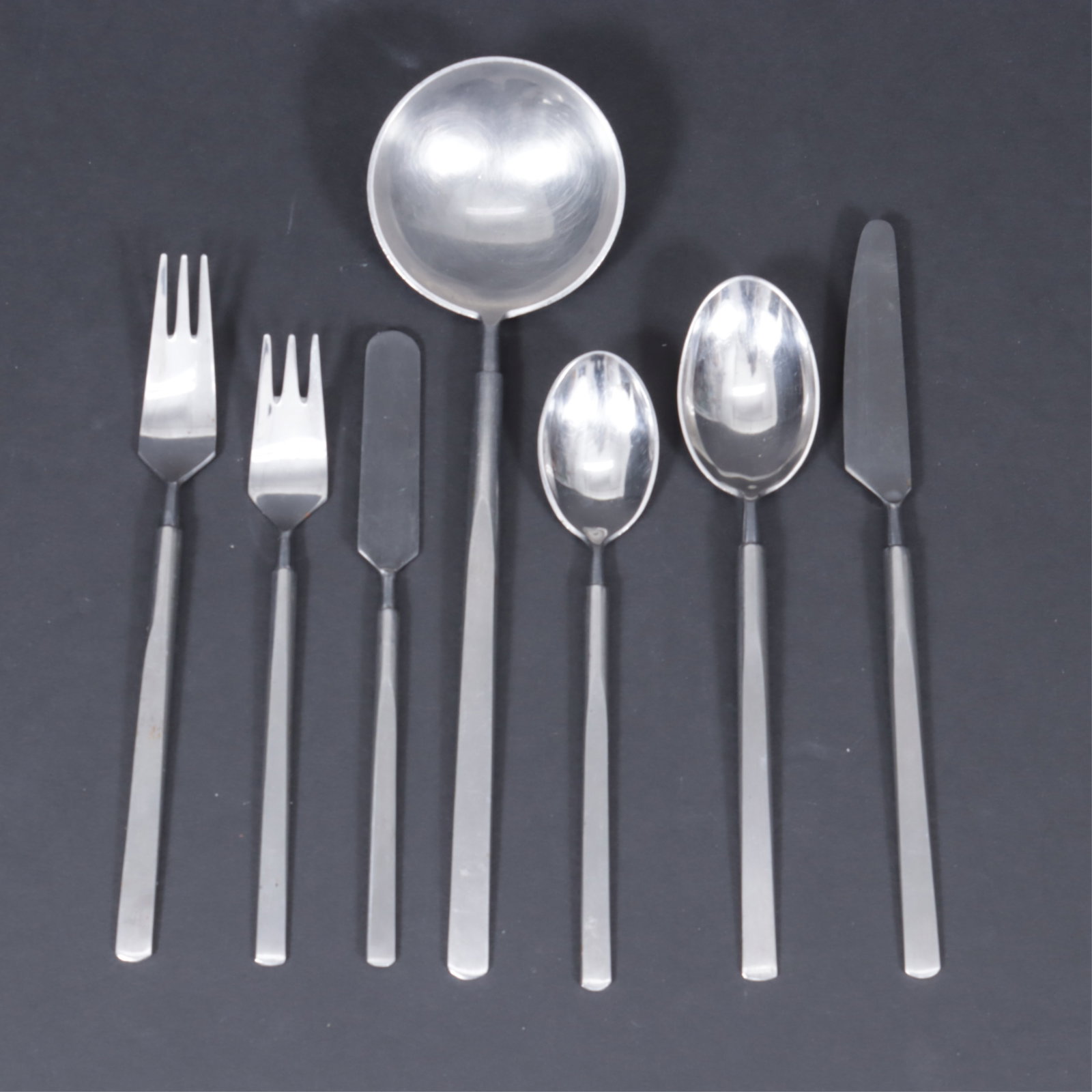 Obelisk Flatware by Erik Herlow: Erik Herlow (1913-1991) for Copenhagen Cutlery. Dinner Forks (6) 7.25" L Smaller Forks (6) Soup Spoons (8) Smaller Spoons (8) Knives (8) Smaller Knife (1) Large Serving Spoon (1). All pieces marked