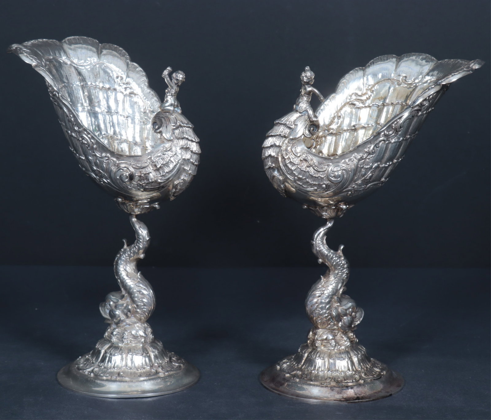 German Sterling Silver Snail Compote Goblets: Pair of .800 German sterling silver Snail Compote Goblets, Swedish import stamps to underside, first half of 20th C., putti resting atop c-scroll, intricate scallop of shell, dolphin stem, total