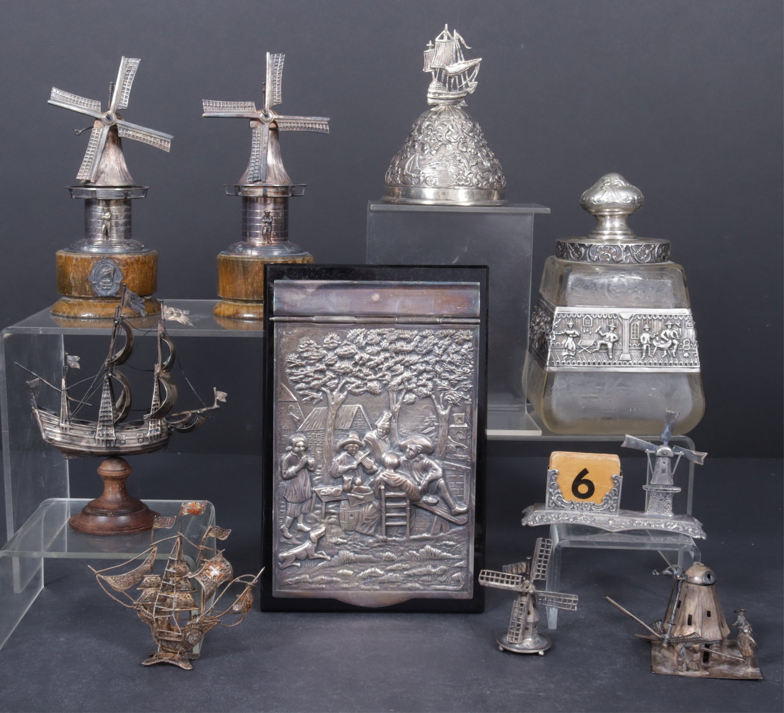 Dutch Sterling Silver Desktop Objects: Dutch sterling silver desktop objects comprised of Dutch bell, c.1945, a Herman Hooijkaas, Schoonhoven, Netherlands, Dutch windmill calendar stand and repousse hinge lidded notepad holder, an unmarked