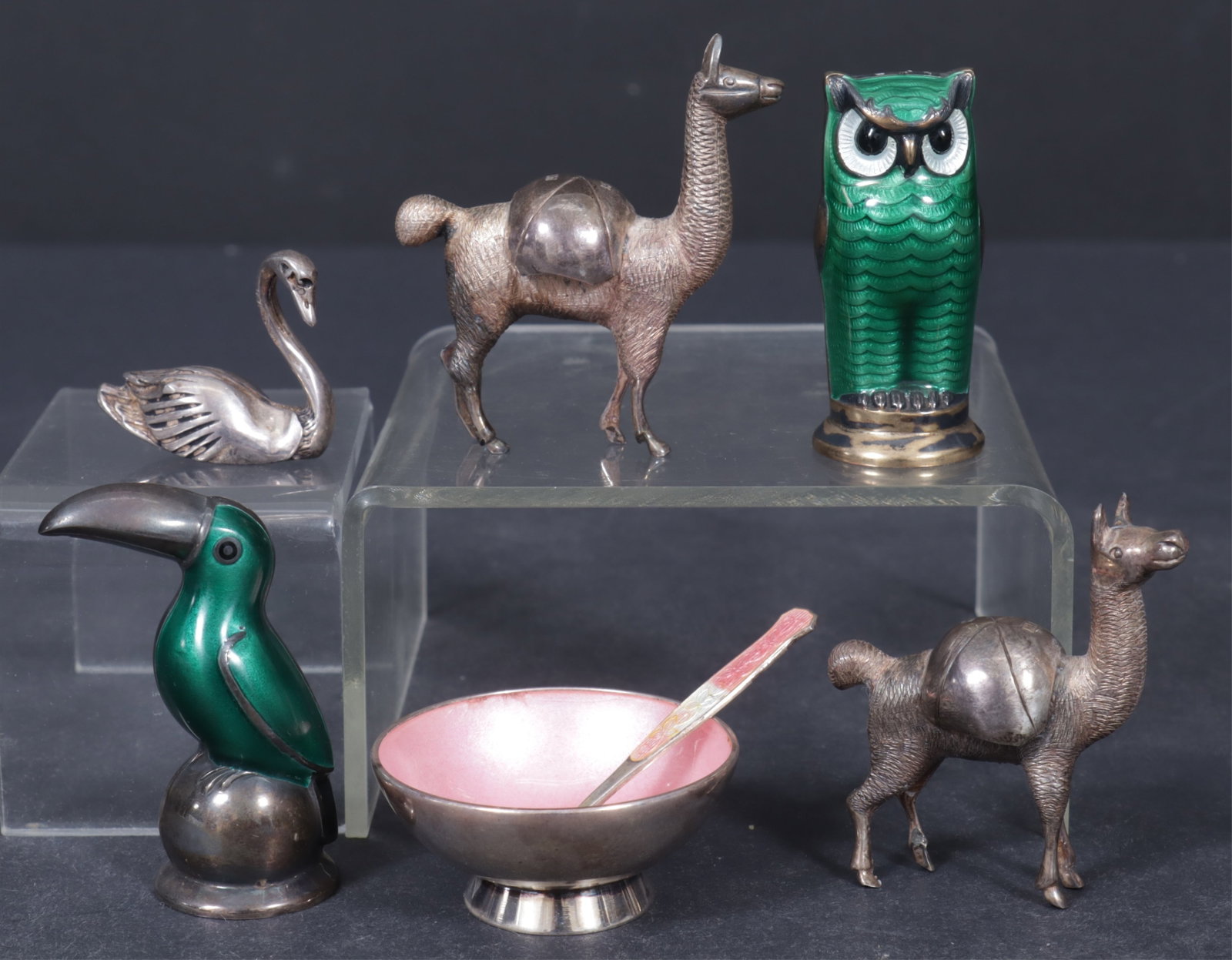 Group of Sterling Silver Miniature Table Objects: Group of sterling silver miniature animals and tabletop objects includes two Peruvian .925 silver llamas; Danish M&N sterling and enamel salt cellar; a .925 swan; a green painted toucan salt