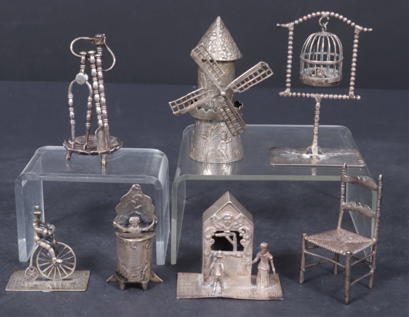 7 Mostly Dutch Sterling Silver Miniature Objects: Group of seven mostly Dutch sterling silver miniature objects, includes, a cyclist, marked Holland .830.; 2 figures watching marionette stage, marked Holland .830; a birdcage on stand, marked BT; a wi