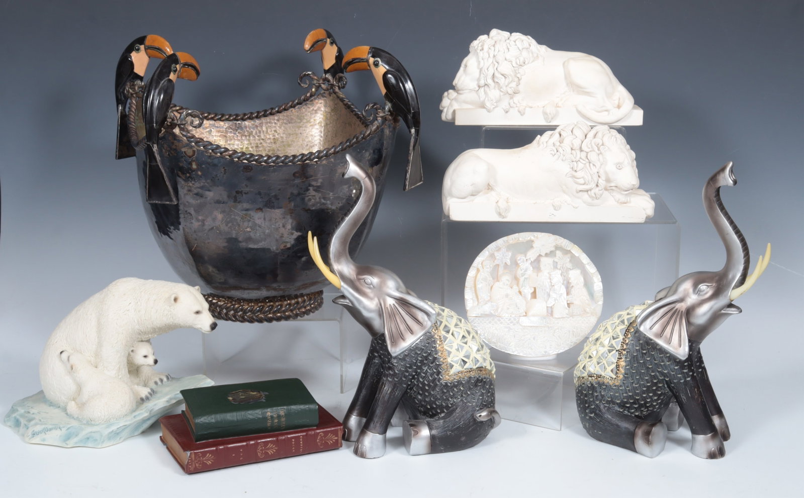 Contemporary Animal Grouping: Contemporary Resin & Metal Animal Grouping, pair lions & elephants, polar bear, toucan handled basket, stacked books paperweight and shell carving. Basket 12" H