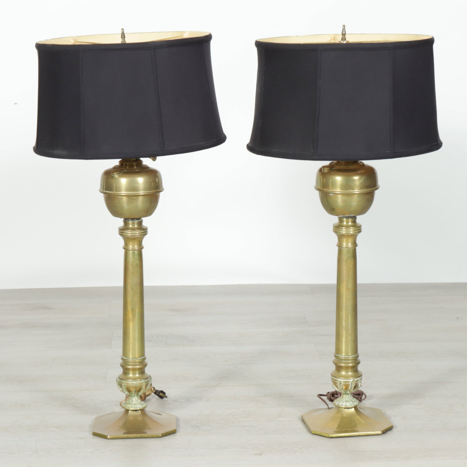 Pair English Brass Oil Lamps: Pair of Late19th - Early 20th C. English tall brass electrified 2-light oil lamps with eagle talon and feather base, switch located along base, bases drilled for wiring 39 (top of finial) x 8 W, shade