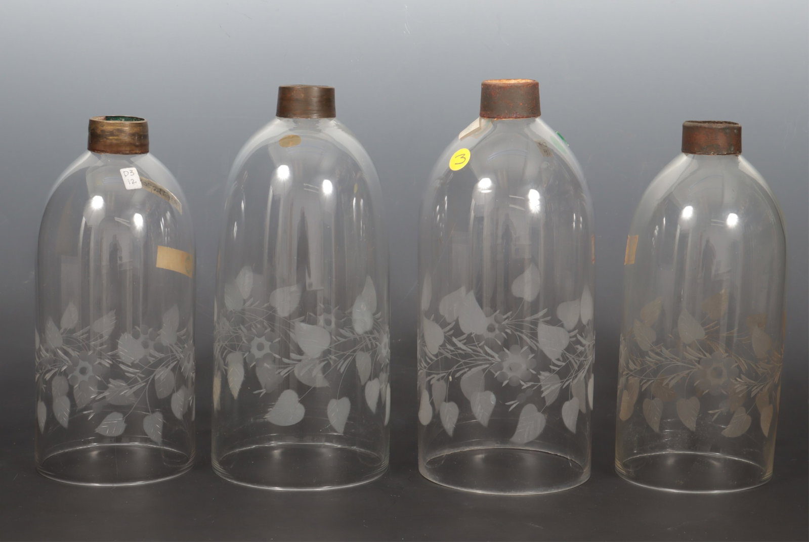 Two Pairs of Antique Etched Glass Hurricane Shades: Two matched pairs of antique glass hurricane shades with etched floral vine motif. 10 1/2" H x 4 3/4" bottom diameter. 11 1/2" H x 5 3/8" bottom diameter.