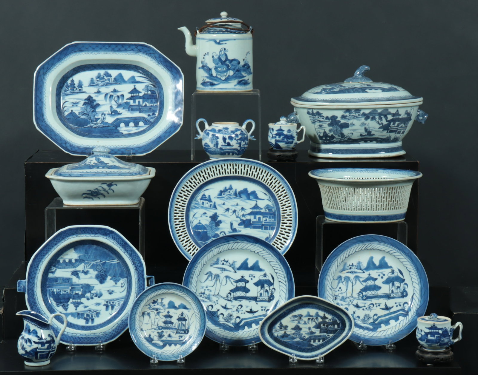 Group of Blue and White Canton Ware: Likely 19th C. Bottoms unmarked. Various Plates, Tureens, Serving pieces. Two small cups on hard wood stands. various sizes
