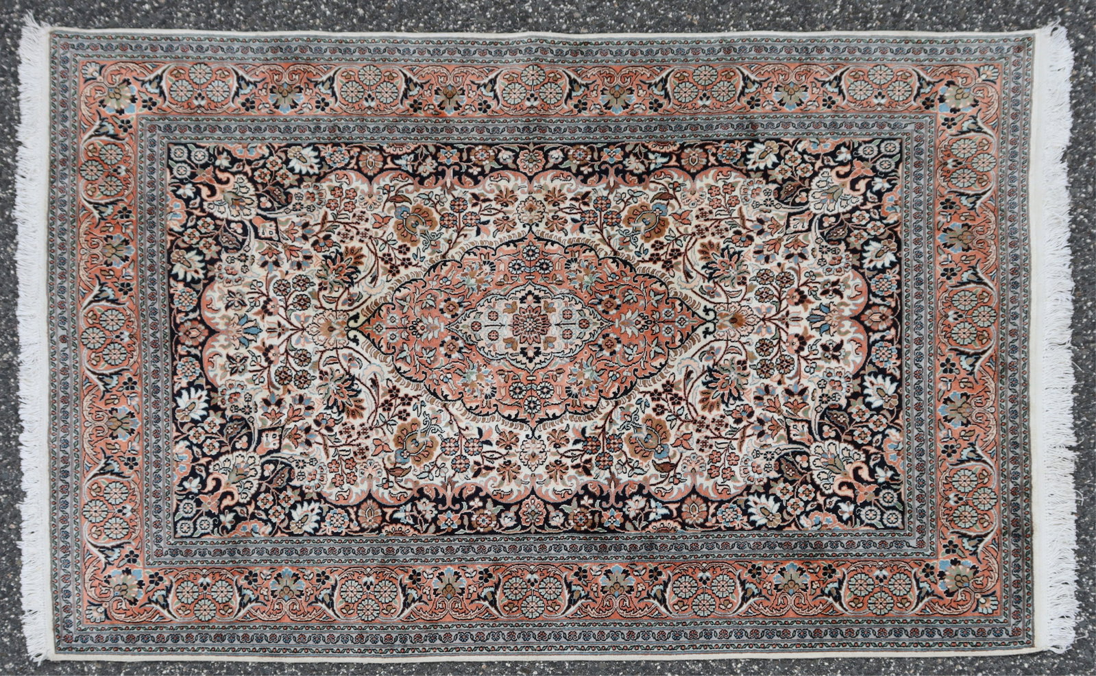 Indian Kashan Style Rug 4-1 x 6-2: Indian Kashan style cotton-silk blend rug, field with ovoid rust ground central medallion followed by and ivory ground quadrant, dark blue ground, banding with rust ground with floral designs 4-1 x 6-
