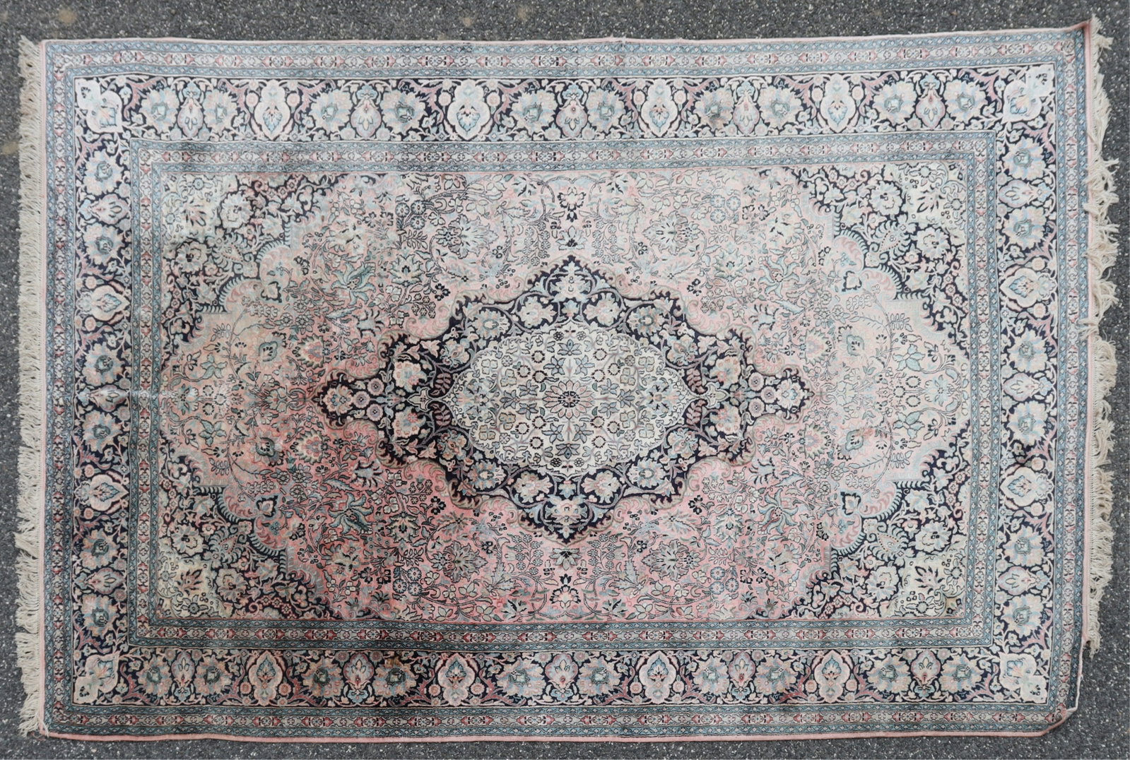 Persian Kashan Style Rug 5-10 x 9-3: Persian Kashan style cotton-silk blend rug, central medallion with off white ground and floral motifs, followed by alternating rose and dark blue ground colors, floral patterns throughout, colors incl